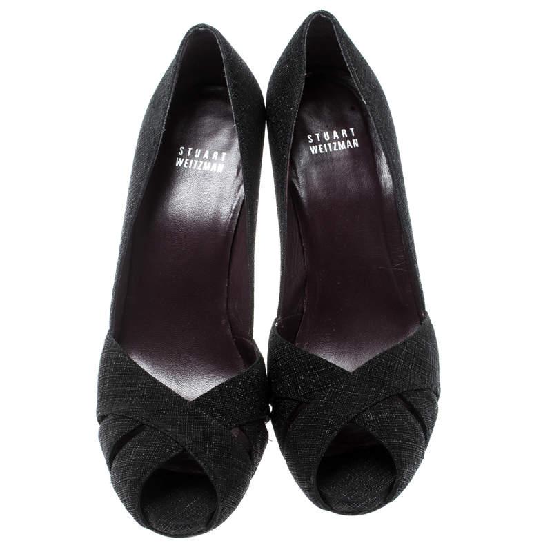 Dazzle wherever you go in these fabulous pumps from Stuart Weitzman. Beautifully crafted, they carry a classic black hue, open toes and comfy insoles. Lastly, the platforms and the 11.5 cm heels will give you confidence in every walk.

