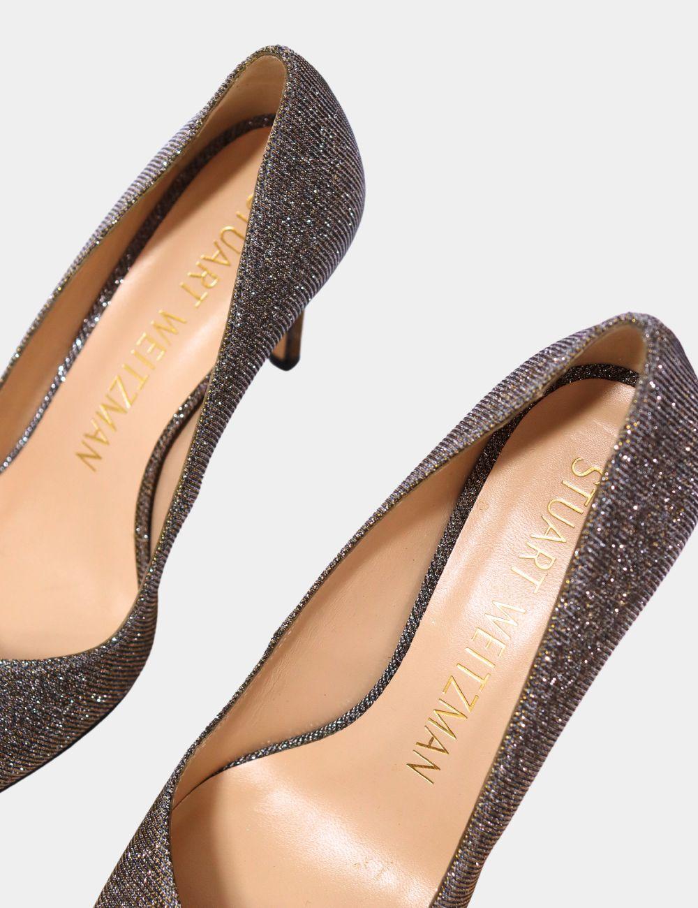 Step into the spotlight with these shimmering Stuart Weitzman Glitter Pointed Toe Pumps. Crafted with a sparkling fabric upper and a sleek stiletto heel, these pumps offer timeless elegance with a glamorous twist. The pointed toe elongates the leg,