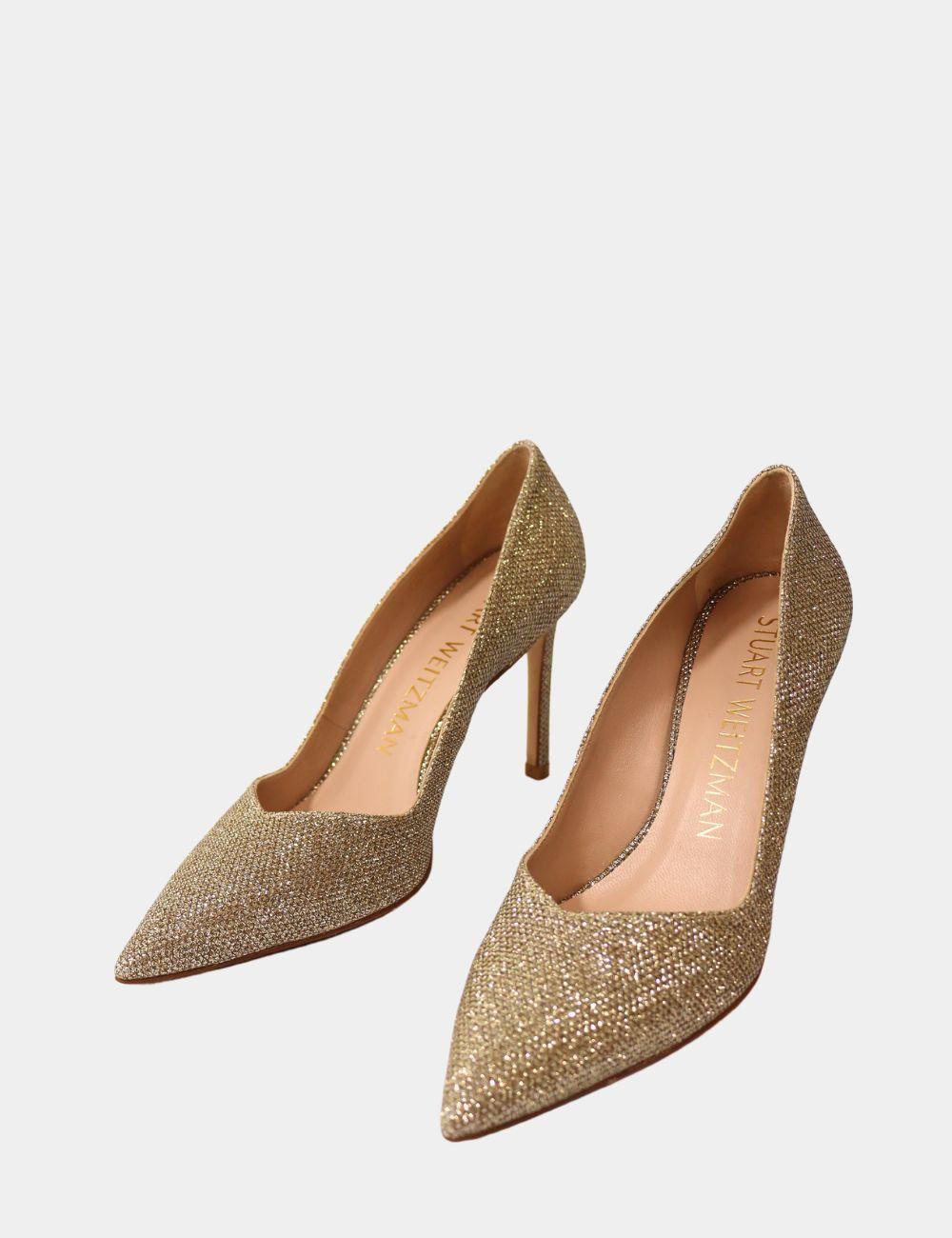 Add sparkle to your step with these glamorous Stuart Weitzman Gold Glitter Pumps. Designed with a sleek pointed toe and slender stiletto heel, these pumps bring elegance and shine to any ensemble. Perfect for weddings, cocktail parties, or special