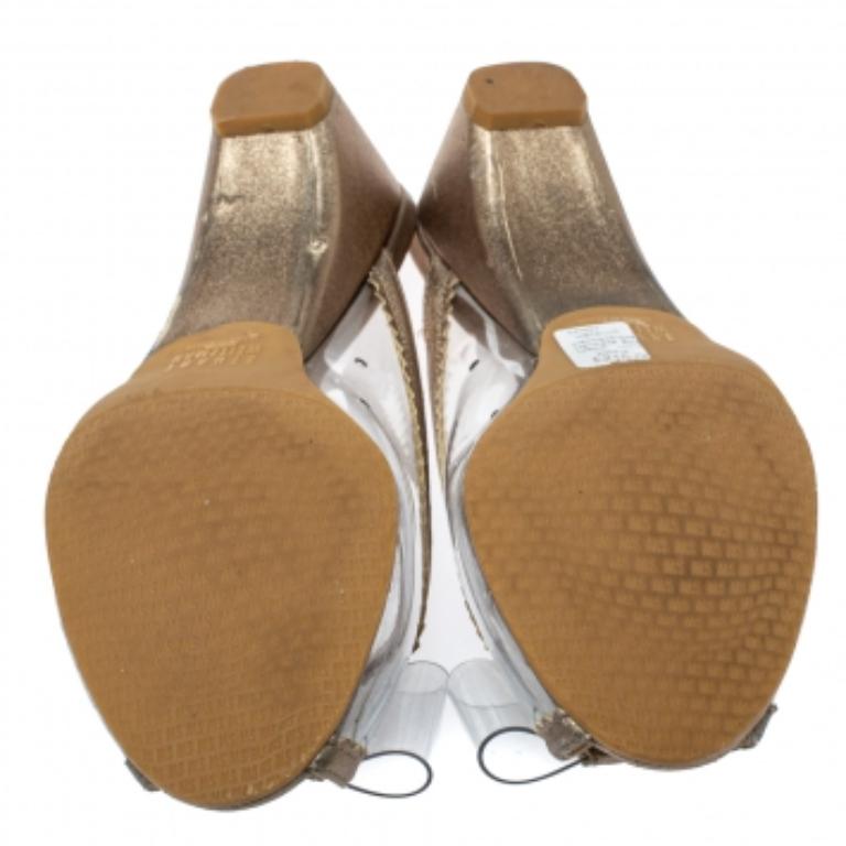 These PVC slides by Stuart Weitzman are easy to slip on and off. They are set on low block heels and come decorated with bows on the vamps. Wear yours with casual dresses and keep the look coordinated with elegant accessories.
