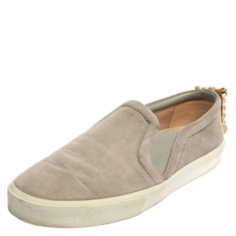 Ready to offer comfort and style, this pair of sneakers by Stuart Weitzman will make a fantastic addition to your shoe collection. They've been crafted from grey suede and styled with crystal details on the counters. They are complete with white