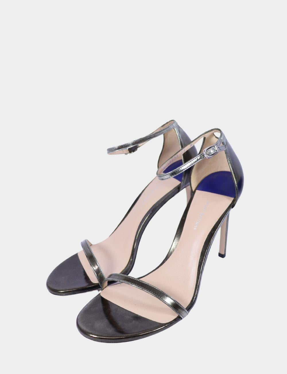 Ces sandales à talon aiguille Stuart Weitzman en argent métallisé rehaussent votre tenue de soirée. Conçus avec des lignes épurées et minimalistes, ces talons à bout ouvert sont dotés de fines brides à l'avant et à la cheville pour une allure