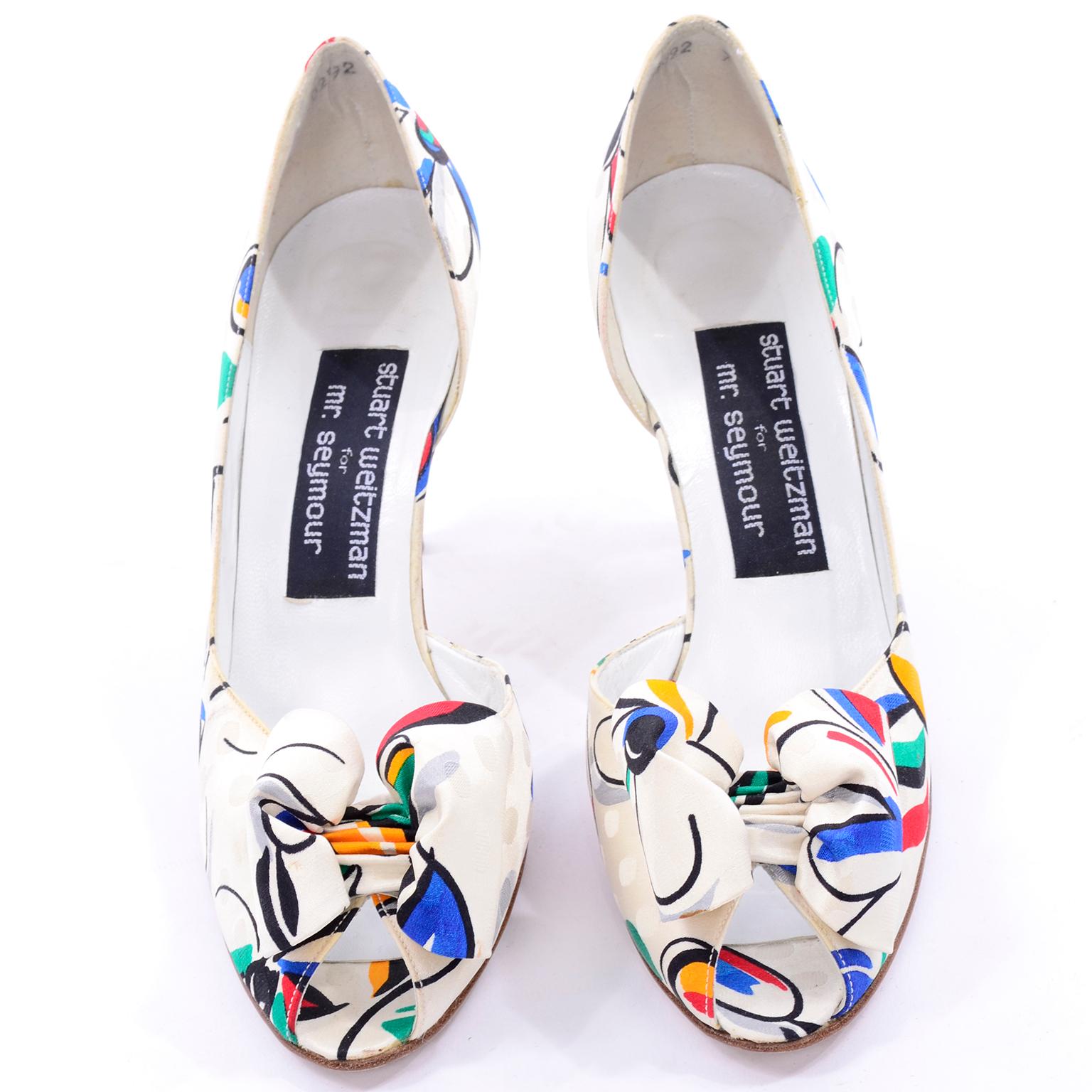 These are the cutest peep-toe Vintage shoes from Stuart Weitzman for Mr. Seymour! These fabulous 1980's shoes are so unique with their bold red, green, blue and yellow floral print fabric. The base of the fabric is white with a tone on tone design.