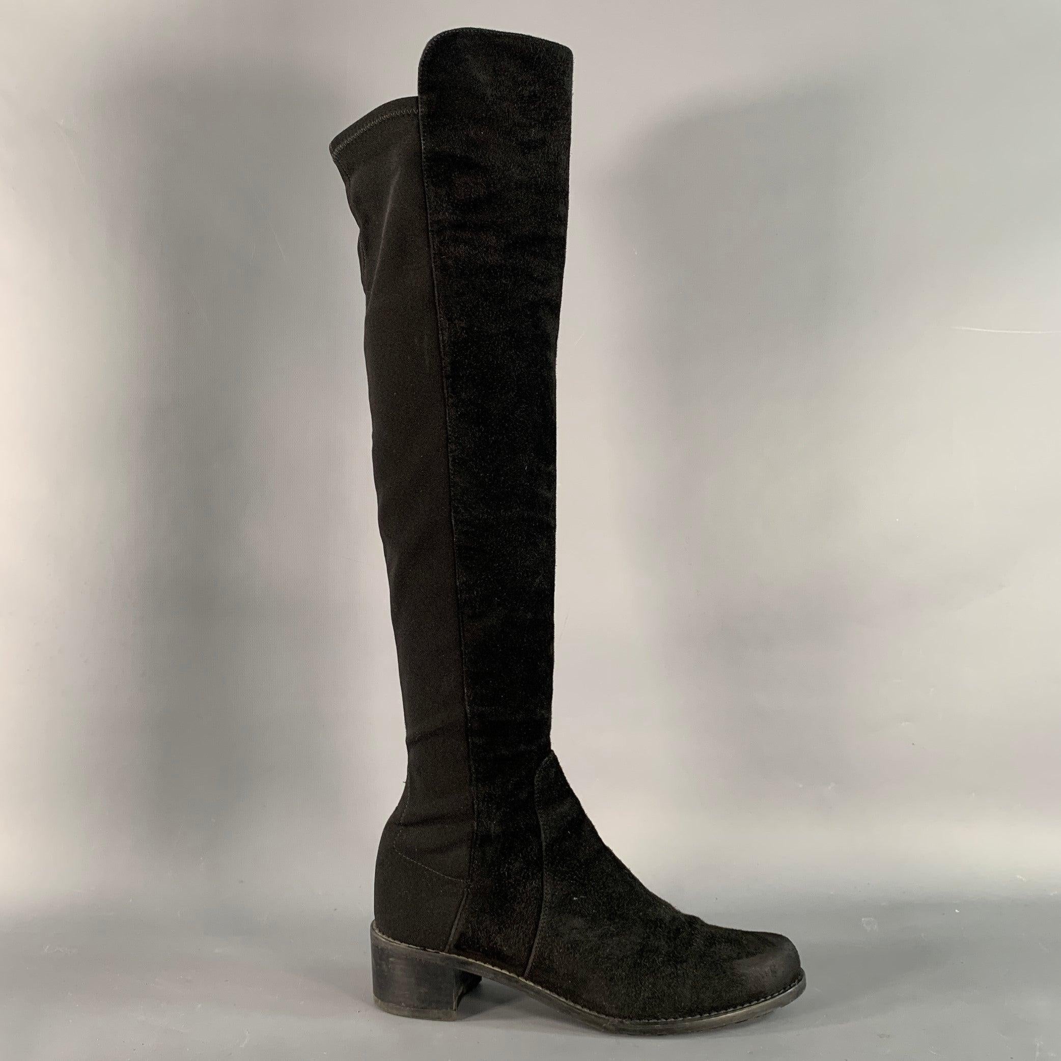 STUART WEITZMAN boots in a black suede featuring a knee high style, stretchy elastic back, and pull on closure.Very Good Pre-Owned Condition.  

Marked:  56641 6 M 

Measurements: 
  Length: 10 inches Width: 3.5 inches Heel: 2 inches Height (with