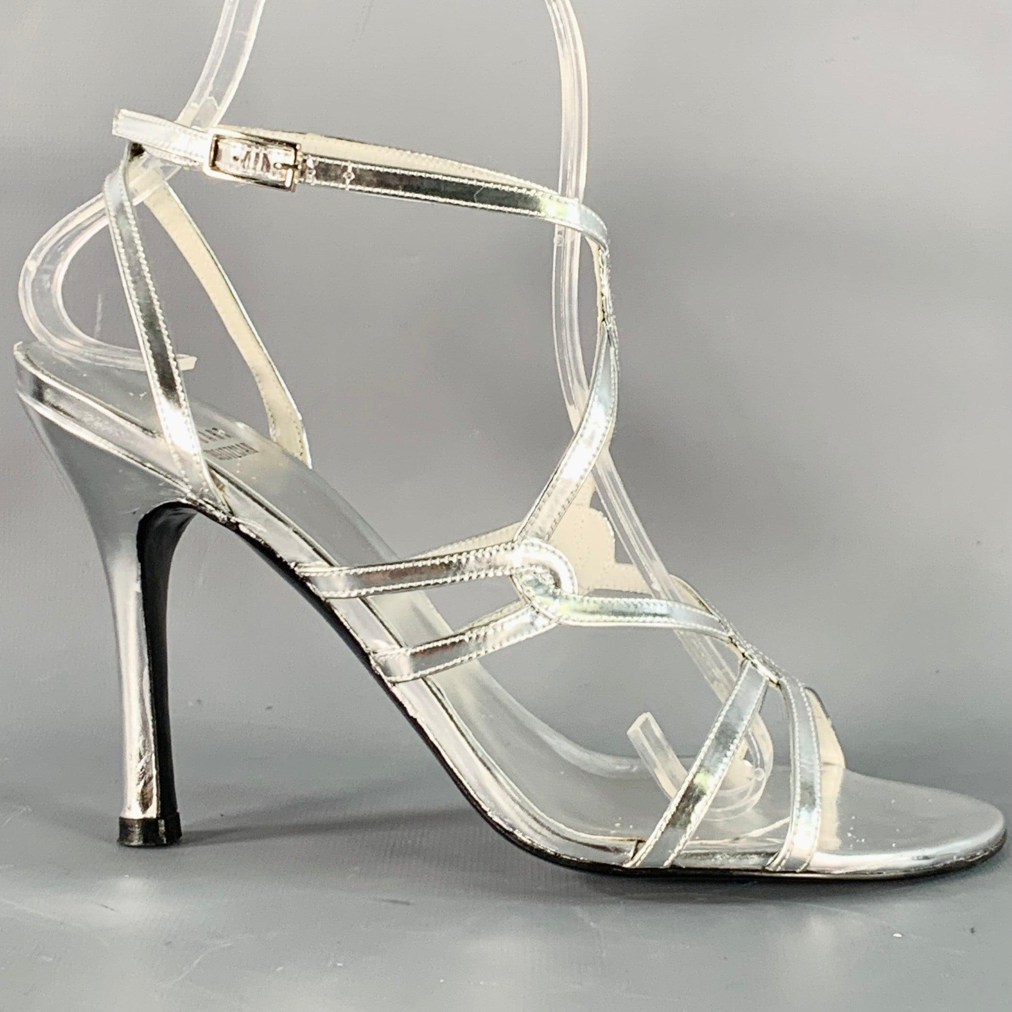 STUART WEITZMAN sandals in a metallic silver tone patent leather featuring a strappy design and ankle strap closure.
Made in Spainches Very Good Pre-Owned Condition. Signs of wear on inside of straps. 

Marked:   BW08416 6M 

Measurements: 
  Heel: