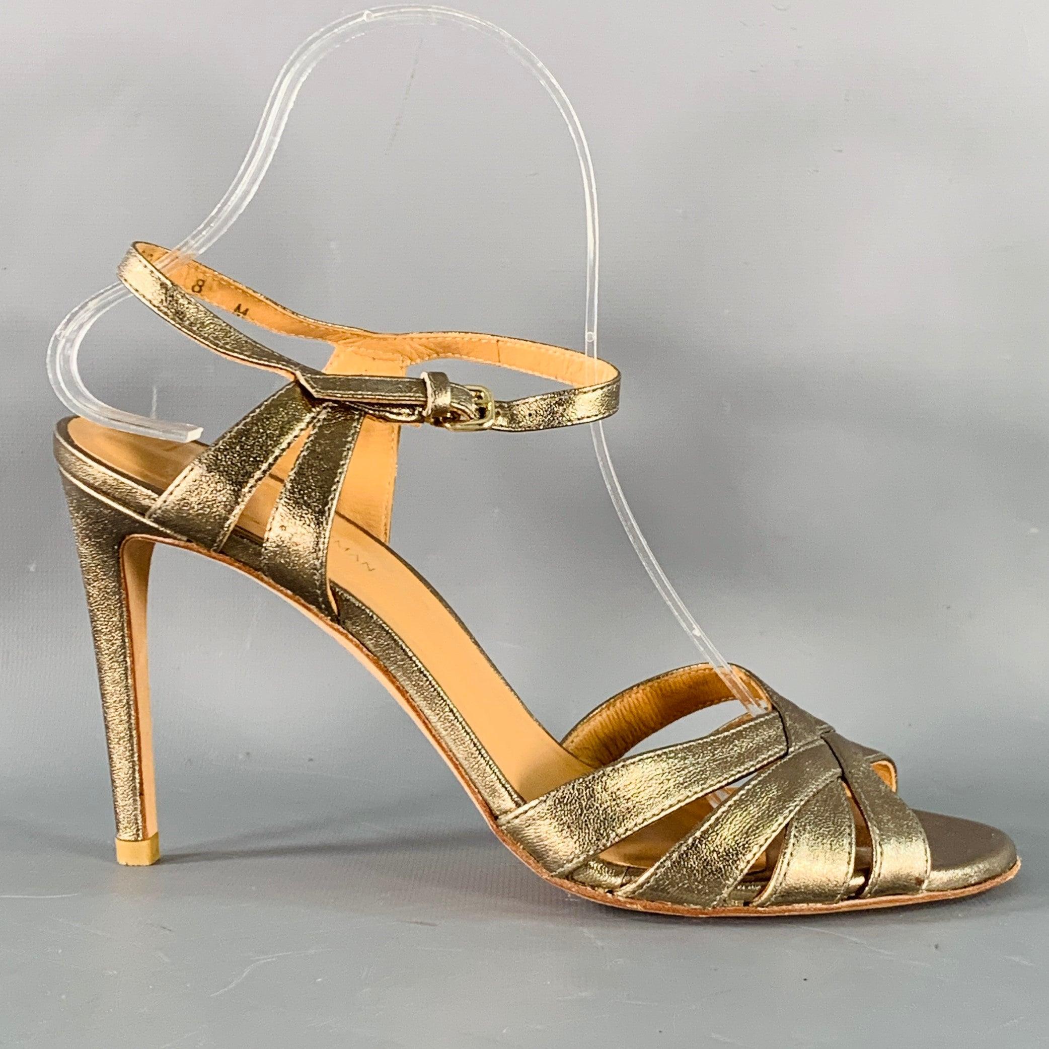STUART WEITZMAN sandals in a metallic gold tone leather featuring a strappy design and ankle strap closure.Very Good Pre-Owned Condition. Signs of wear on soles. 

Marked:   47523 8 M 

Measurements: 
  Heel: 4 inches 
  
  
 
Sui Generis