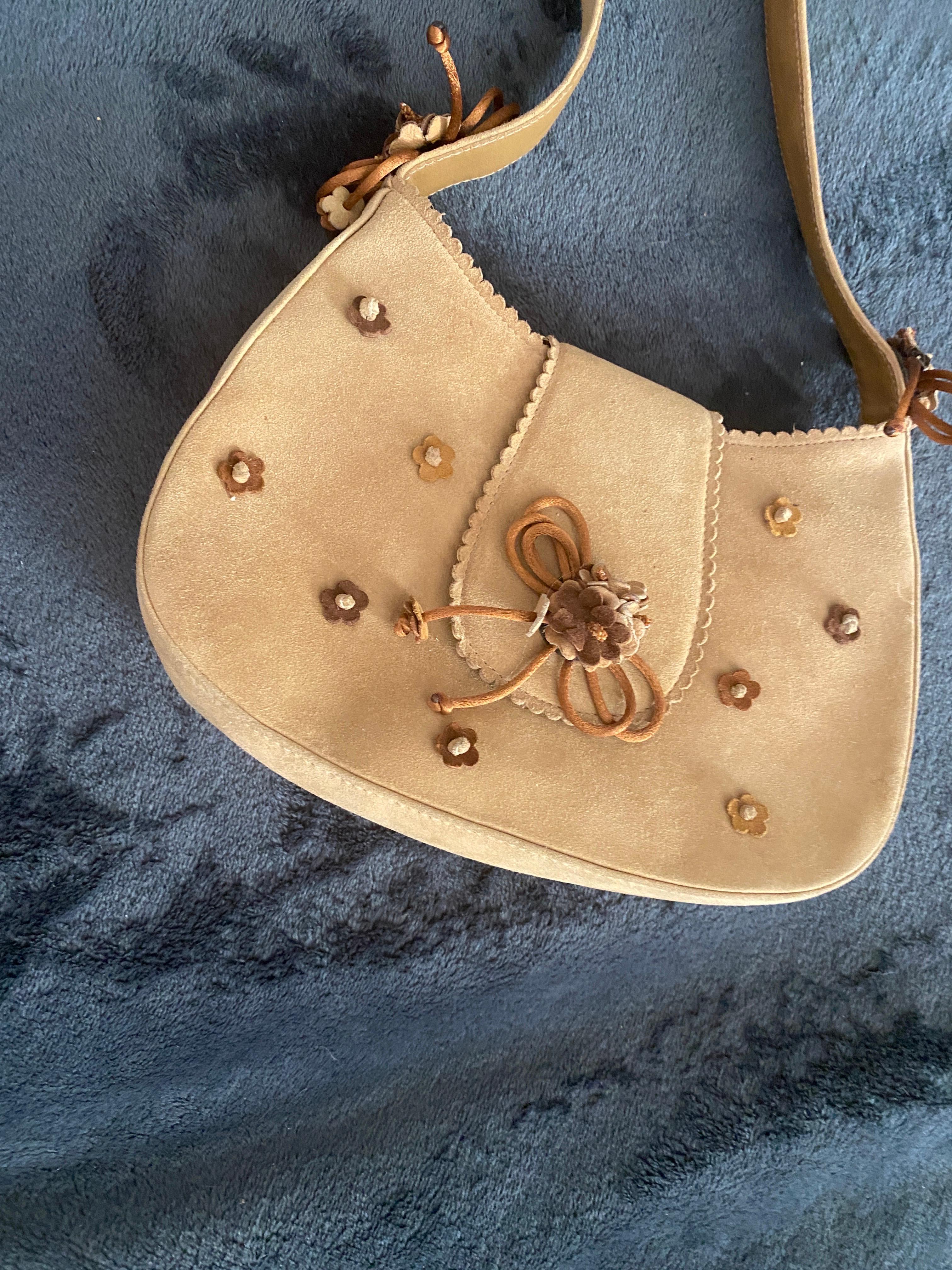 This vintage Stuart Weitzman made in Spain. handbag was purchased from my Palm Springs estate and found in the drawer on used since it was purchased new in NYC. The handbag suede color is hard to photograph correctly. It is a neutral, go with