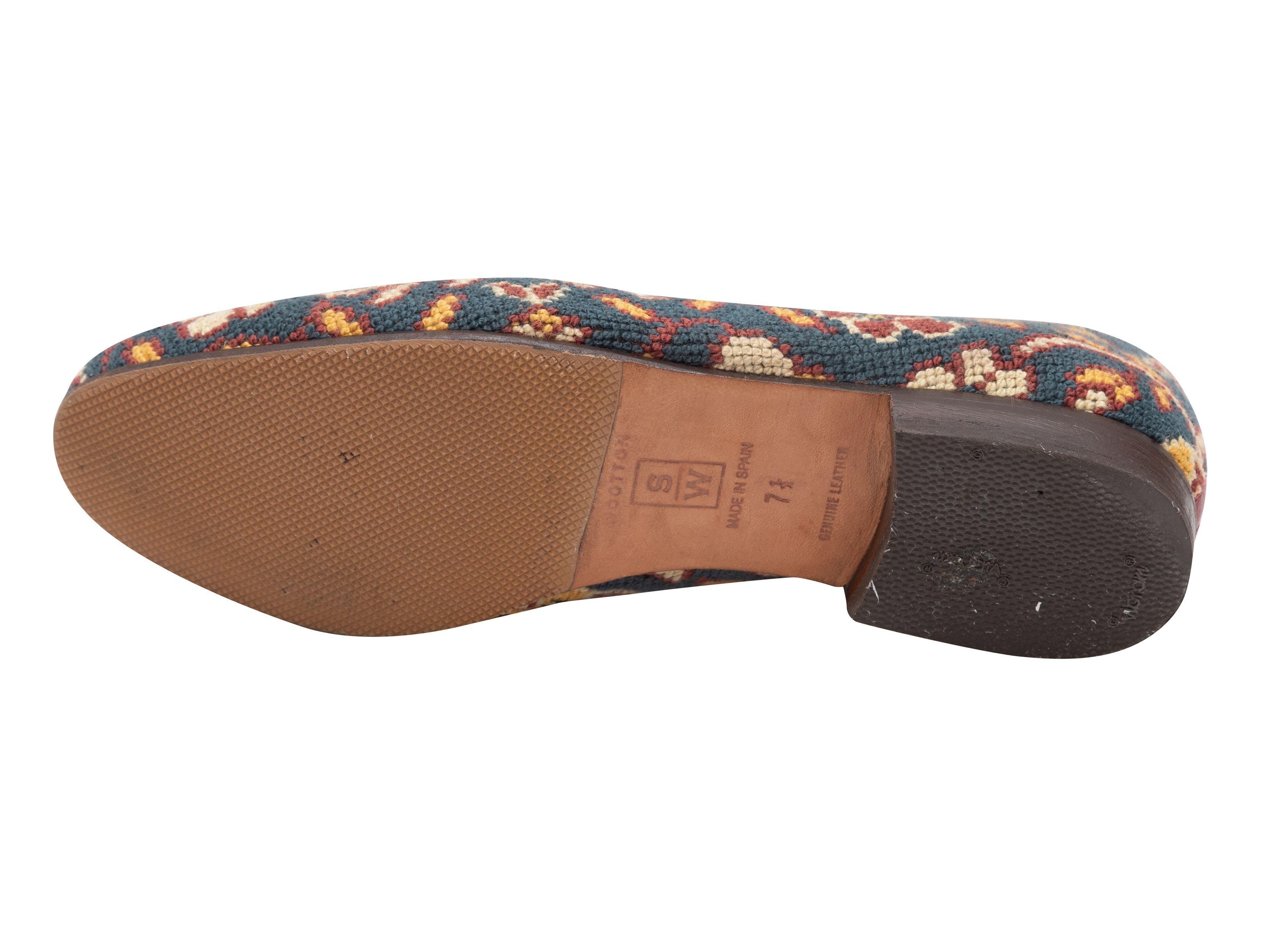Product Details: Blue and multicolor patterned needlepoint loafers by Stubbs & Wootton. Leather trim throughout. 0.75