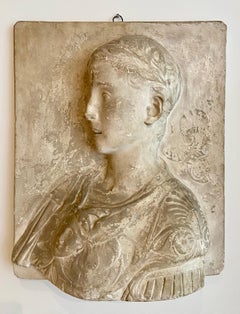Stucco bust of a young roman emperor in relief.