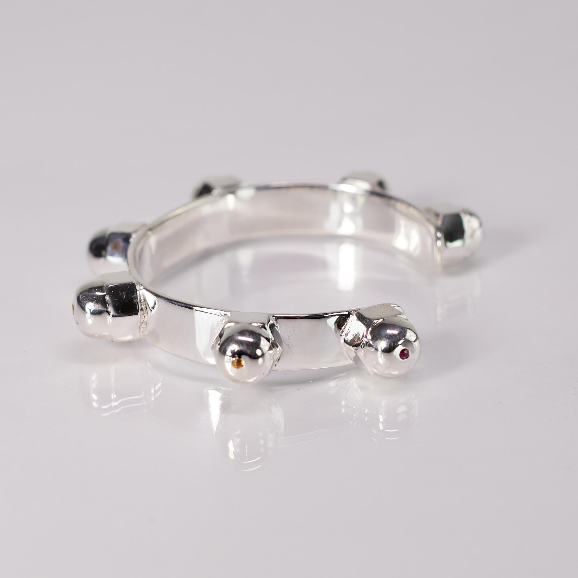 This chakra cuff bracelet by J Dauphin is handcrafted in solid sterling silver and set with seven precious gemstones, each aligned with one of the body’s energy centers. The open statement cuff form allows for comfortable wear on its own, beside a