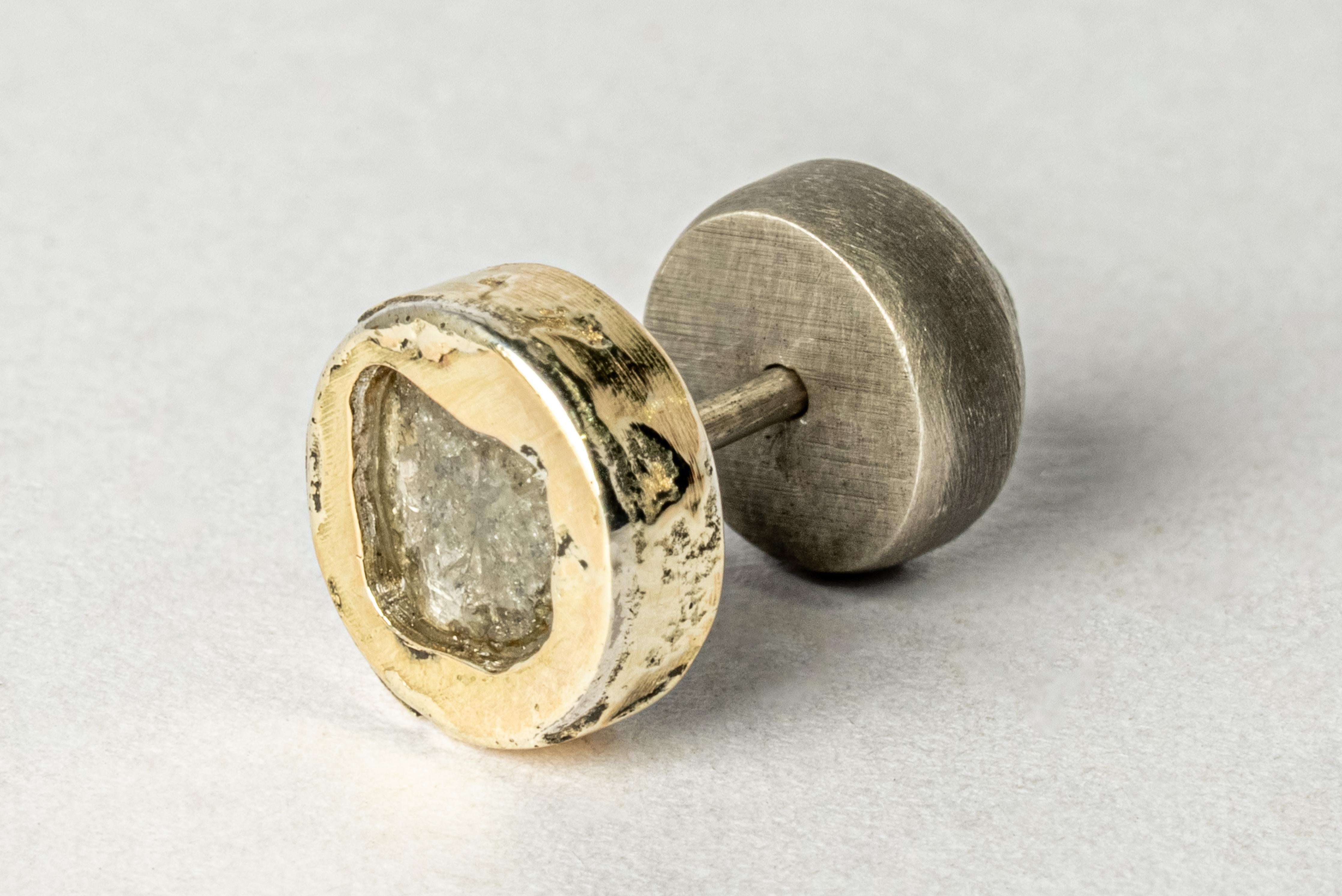 Stud earring in sterling silver, 18k solid yellow gold layer fused on the surface and slabs of rough diamond. These slabs are removed from a larger chunk of diamond. This item is made with a naturally occurring element and will vary from the