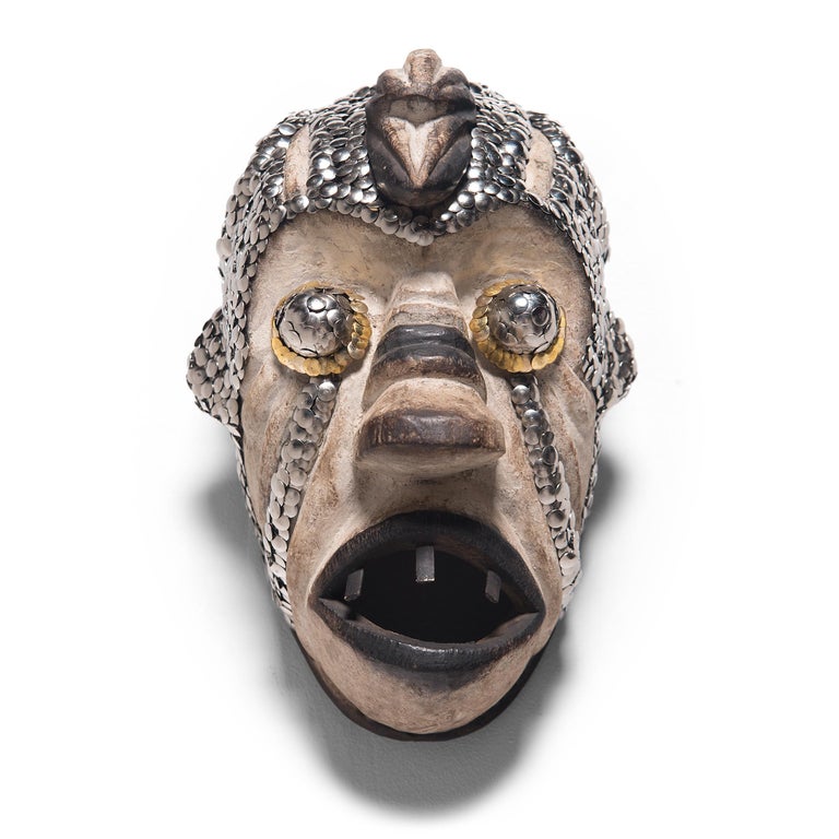 In an exclusive collaboration with Pagoda Red, Chicago artist the bms. adds a contemporary twist to our collection of one-of-a-kind African art objects. Embellishing with silver and gold thumbtacks, the bms. accentuates the sculptural form of this