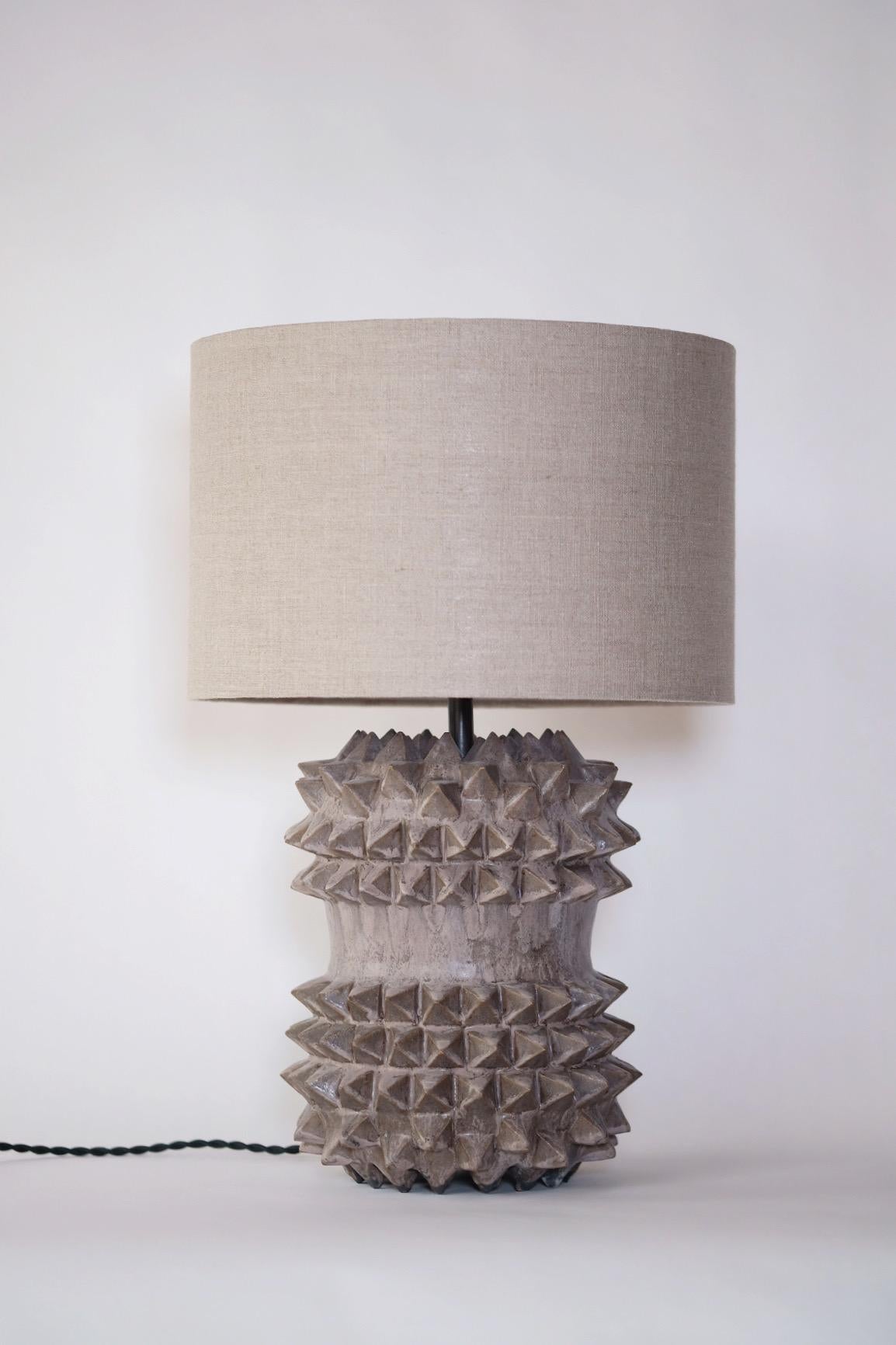 Hand-Carved Studded Stoneware Barrel Table Lamp with Dark Grey Linen Shade by LGS Studio For Sale