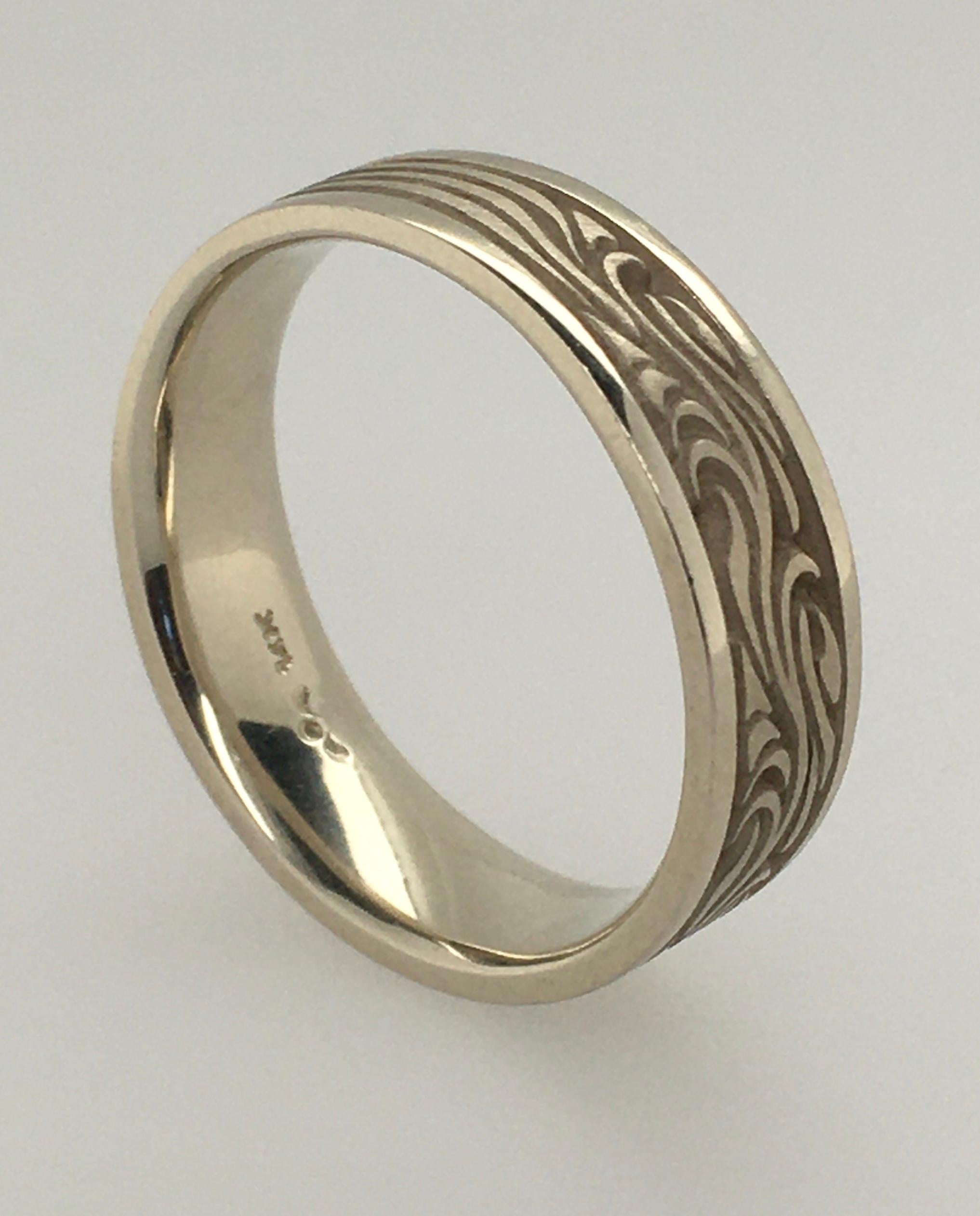 This Starry Night motif by Studio 331 is a 6.75 mm men's 14K white gold wedding band with flat polished rims.  As with all their rings, Studio 311 purposefully designs for Comfort Fit. Note the band's intricate Starry Night design that tapers
