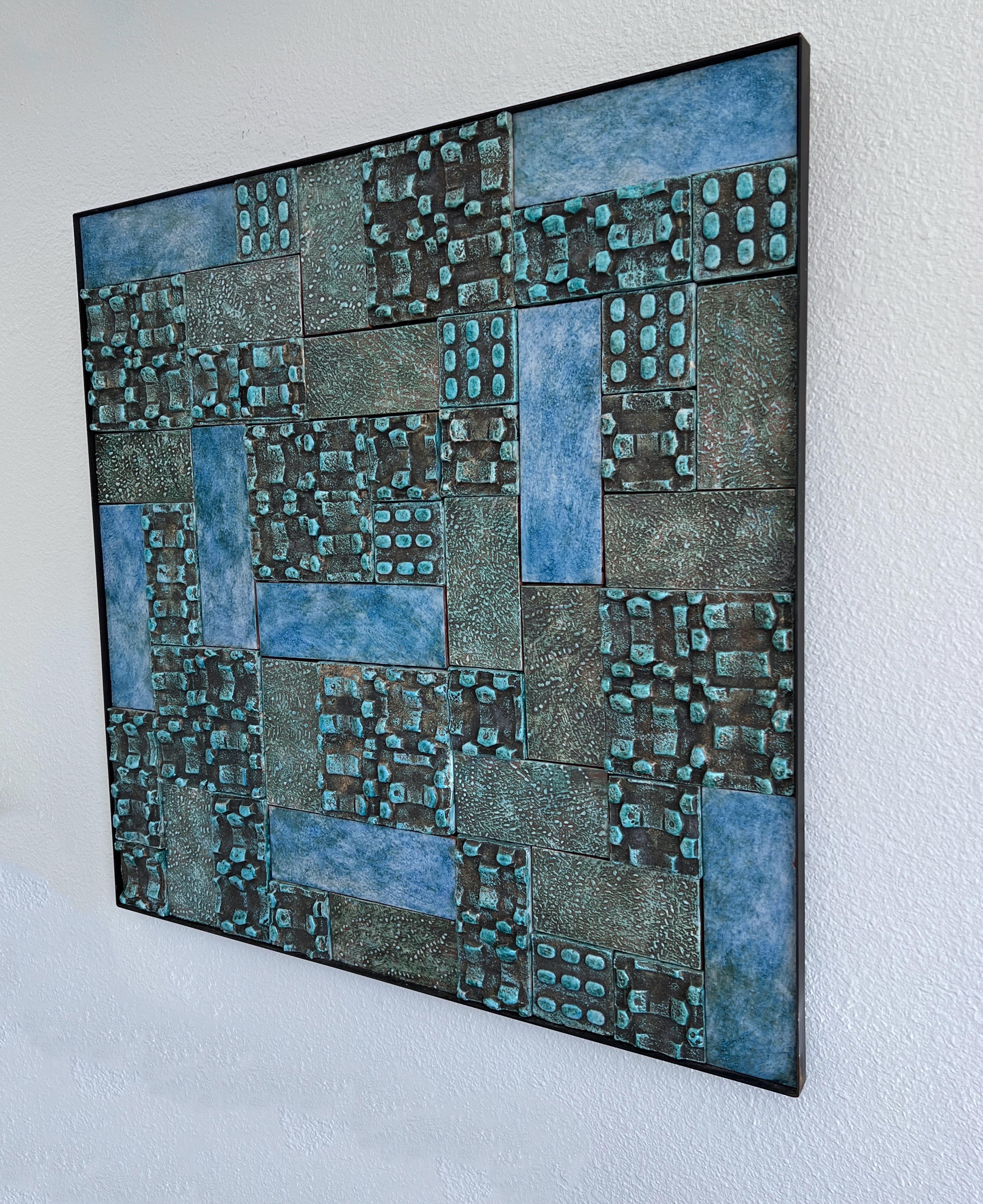 Beautiful studio ceramic glazed abstract mural. 
The glaze is lite blue, turquoise and gray colors. 
Black steel frame. 
Measurements: 39.63” wide 39.63” high, 1.25” deep.