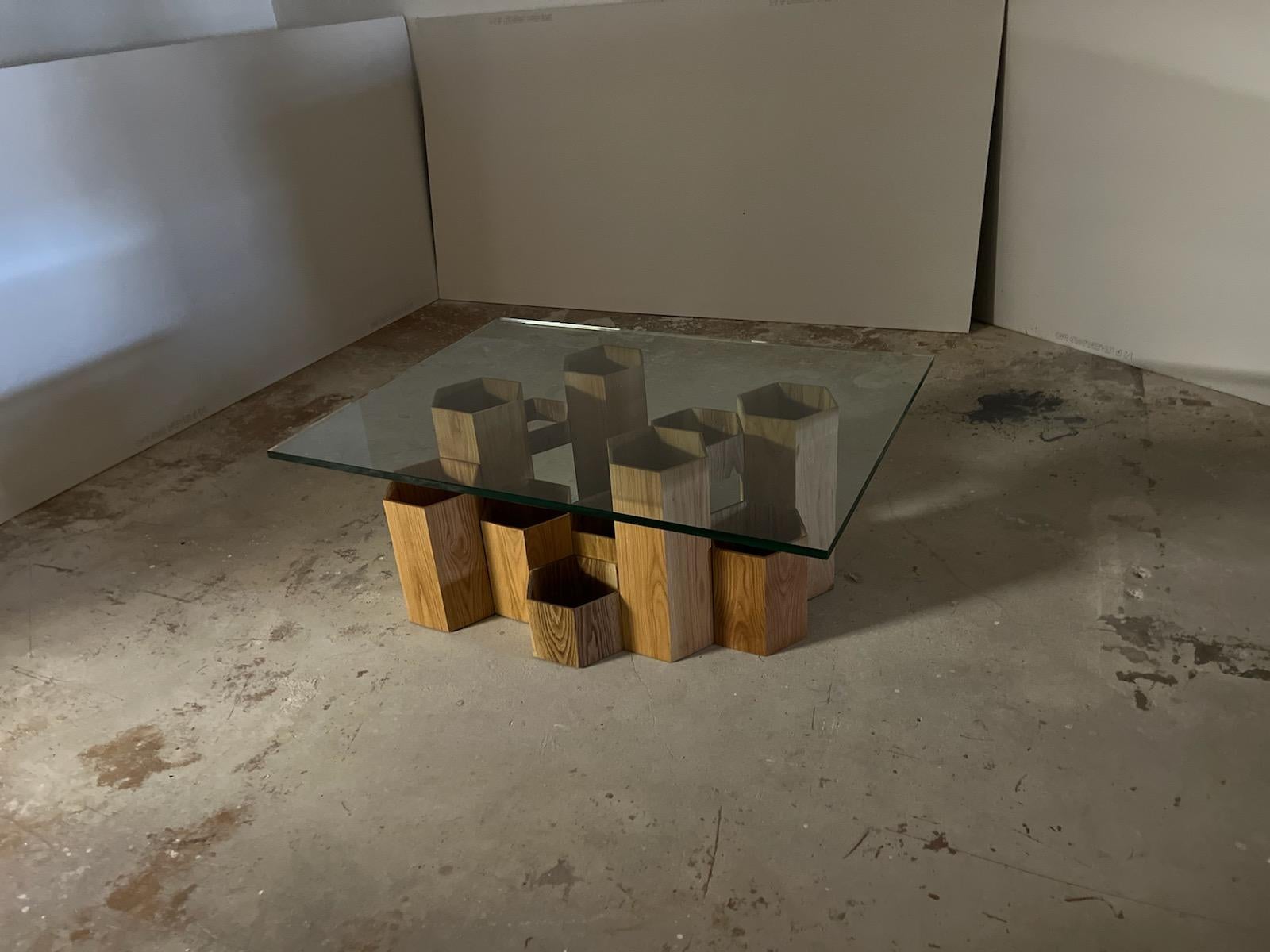 One of two studio apotroes tables inspired by the homes of bees. This solid wood coffee table features hexagonal cells of different heights at different heights to mimic the organic nature of a freshly cut piece of honeycomb. It is a contemporary