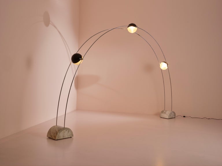 A large ''Ponte'' (Bridge) floor lamp designed by Gruppo A.r.d.i.t.i. for Nucleo Sormani during the 1970s.
This space age lamp is made of two marble bases connected by two thin chrome stems which create a modular arc where three swiveling balls made