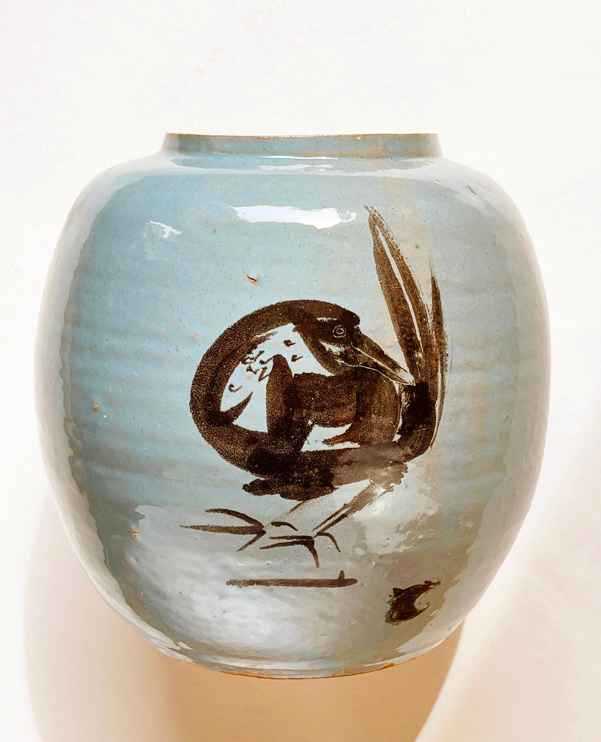 Beautiful, most likely originates in Japan: large round ceramic vase in an eggshell blue to turquoise glaze.
The general style is inspired by the marvellous brush painting style of the Edo period (1603 bis 1868), where all is expressed with just a