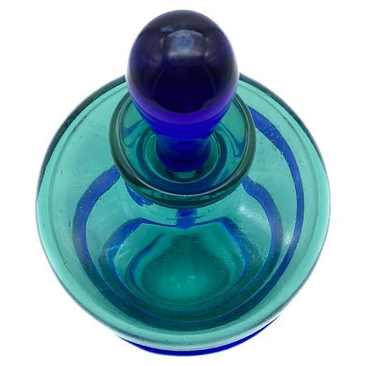 This eye catching studio art glass perfume bottle comes with an aqua blue body and a spiral cobalt appliqué. A cobalt blue stopper dropper completes the ensemble. It recalls the vibrant colors of the shore.

Nouveau Boutique does not just have great