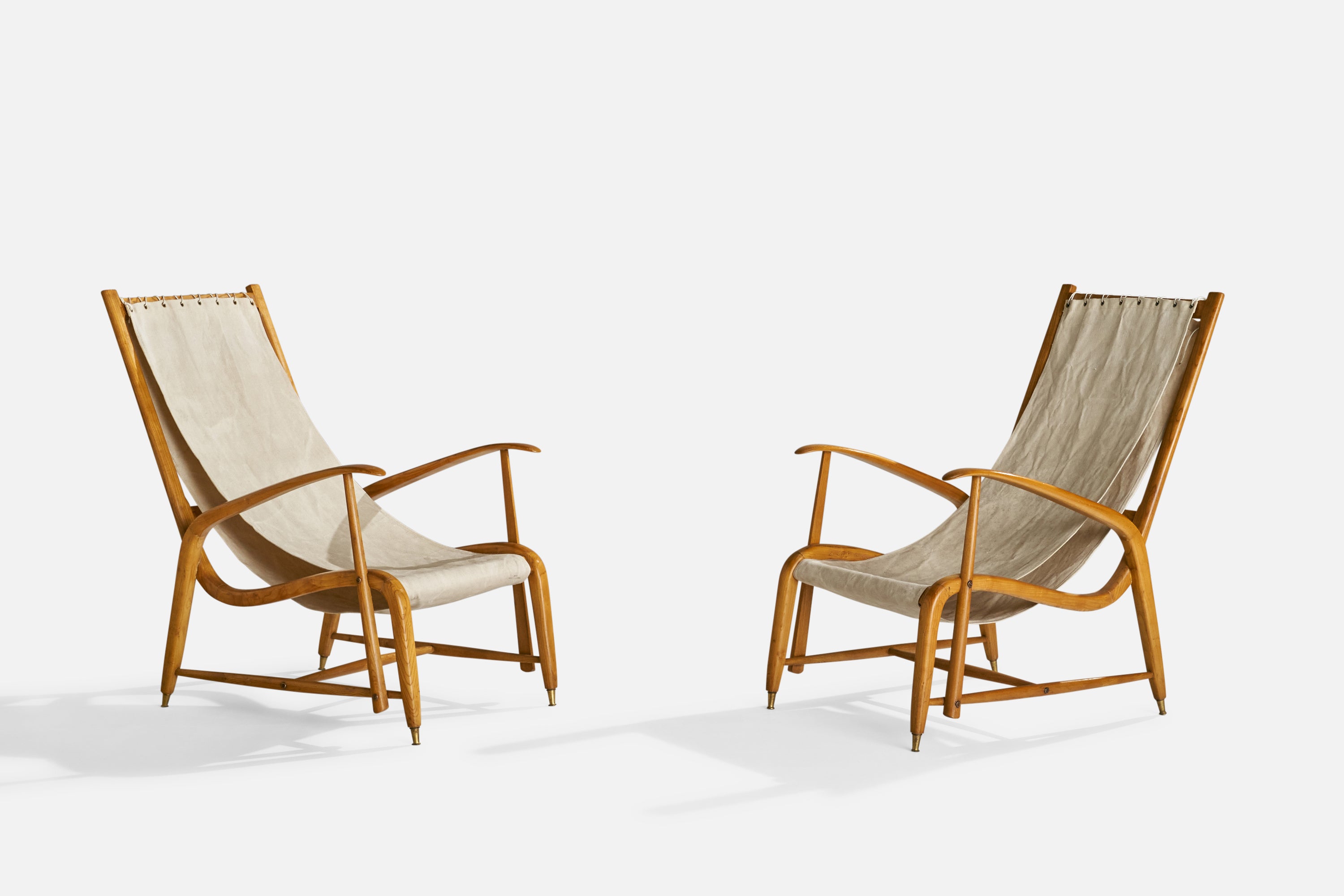 A pair of oak, canvas and brass lounge chairs attributed to Studio BBPR, Italy, c. 1950s.

Seat height 14”.