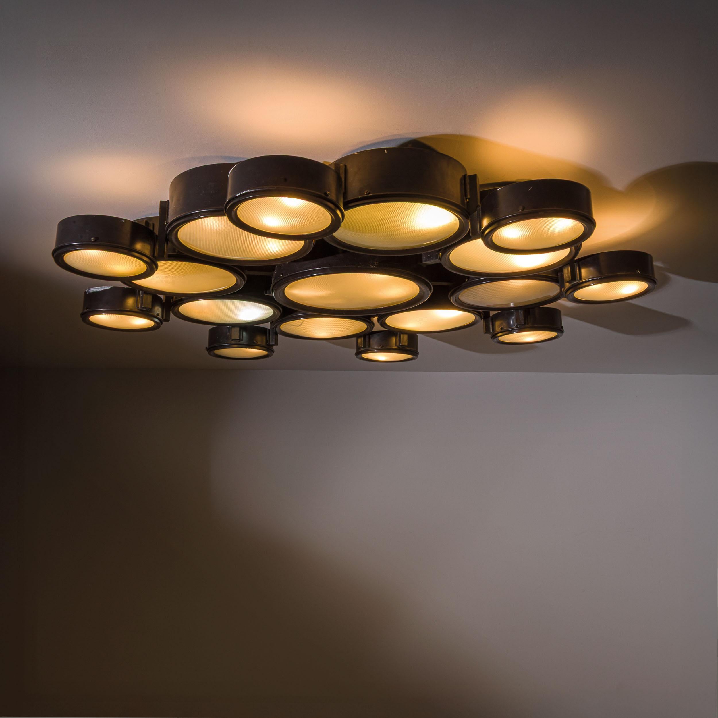 A sculptural and highly architectural ceiling light designed by Studio BBPR for Arteluce in the 1960s—this rare large-scale variant of the model 2045/D is an exceptional example of Italian postwar lighting design.

Composed of 17 individual circular