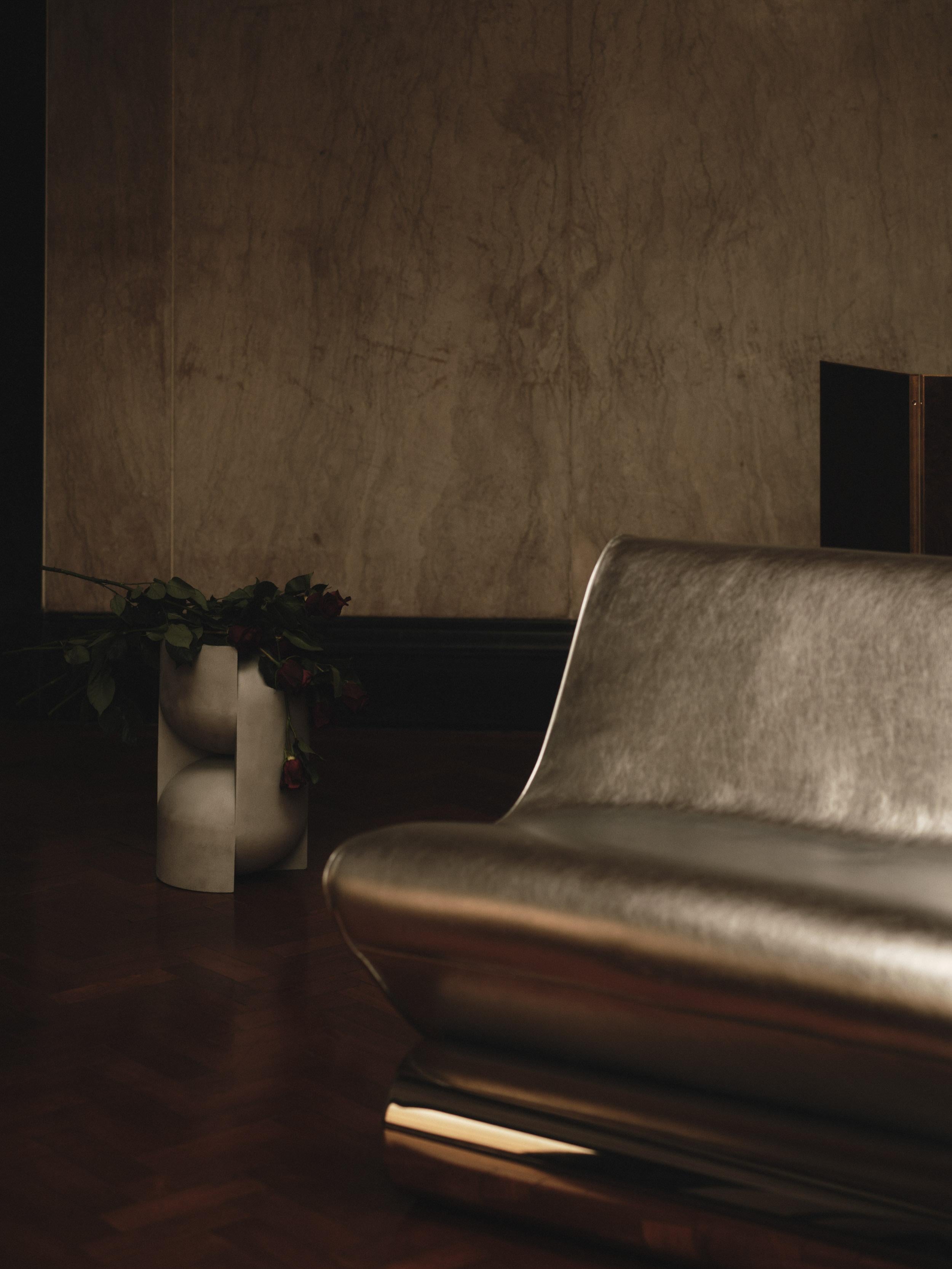 Un'audace ode alle curve iconiche e all'energia grezza dell'era del glam rock, la Vanguard Lounge Chair si ispira alle silhouette delle chitarre elettriche classiche. La sua forma scultorea, avvolta nella nostra pelle Starman Silver, poggia su una