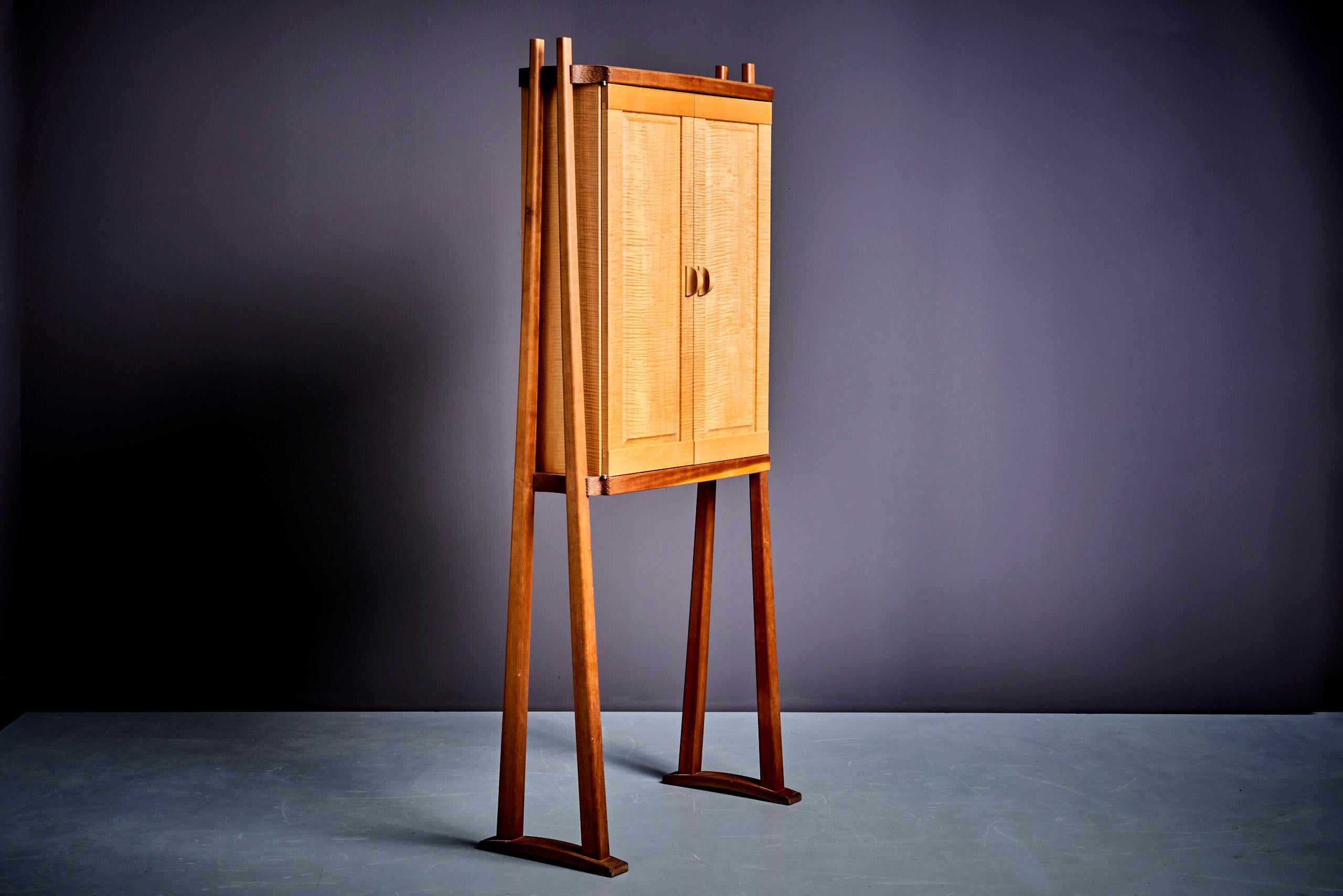 Tall studio cabinet in different woods by American Craftsman Mike Bartell 1989
Two doors and two insert shelves in glass.