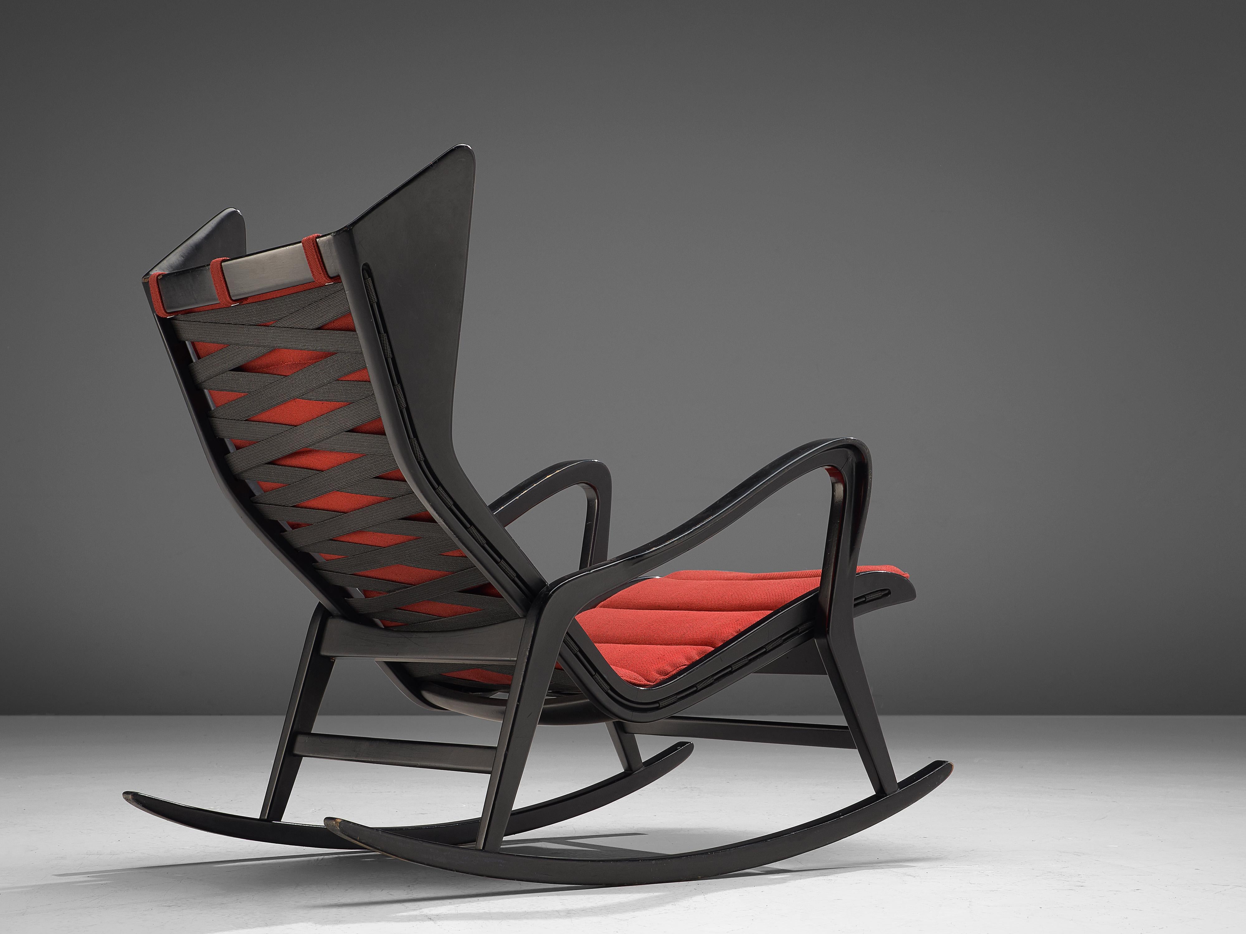 Cassina, lounge chair model 572, darkened wood and red fabric, Italy, 1950s.

This rocking chair in ebonized wood is designed and produced by the Italian company Cassina. This chair is the epitome of high-quality Italian furniture design of the