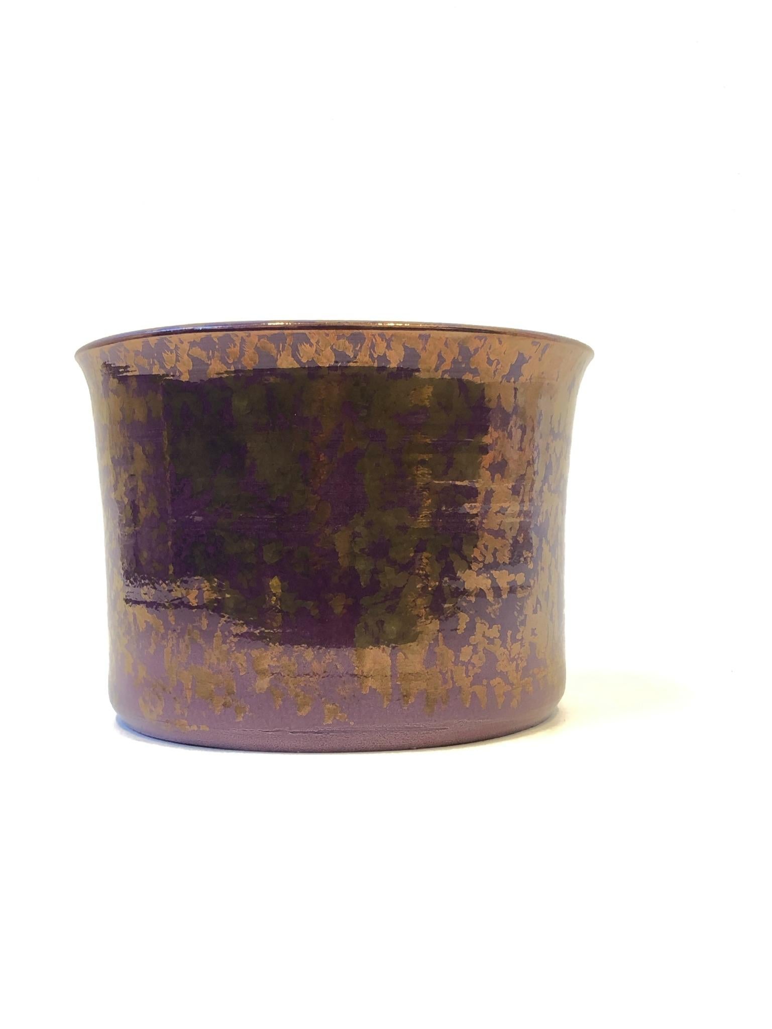 1980s Studio ceramic planter or cachepot with purple and copper glazing by Gary McCloy for Steve Chase. Hand signed and marked exclusively for Steve Chase. Price is just for one planter.
Measurements: 7.5 high and 11” diameter.
