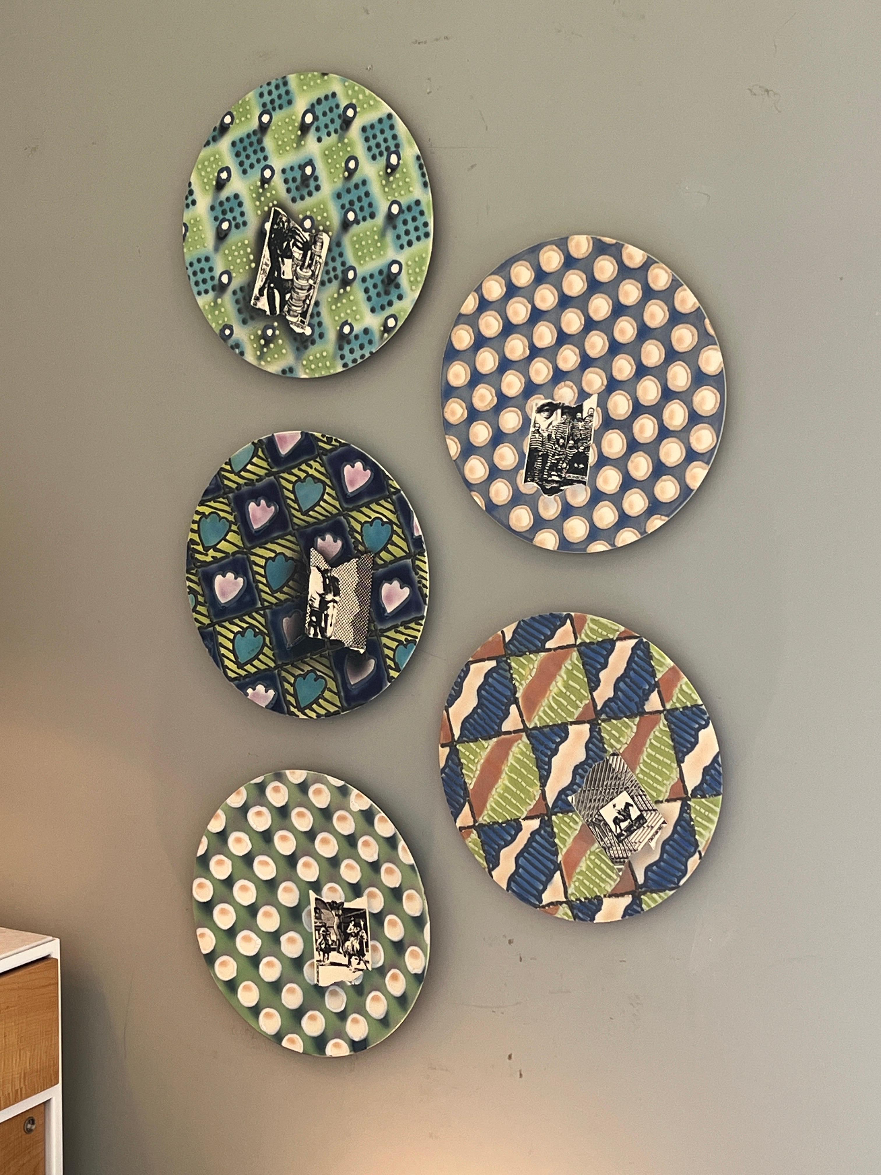 Ceramic chargers with photo transfer by prolific California artist Erik Grönborg . Arriving in the United States from Denmark in 1959, Grönborg headed straight away to California where he's been a trailblazer in the creation of Funk ceramics, cast
