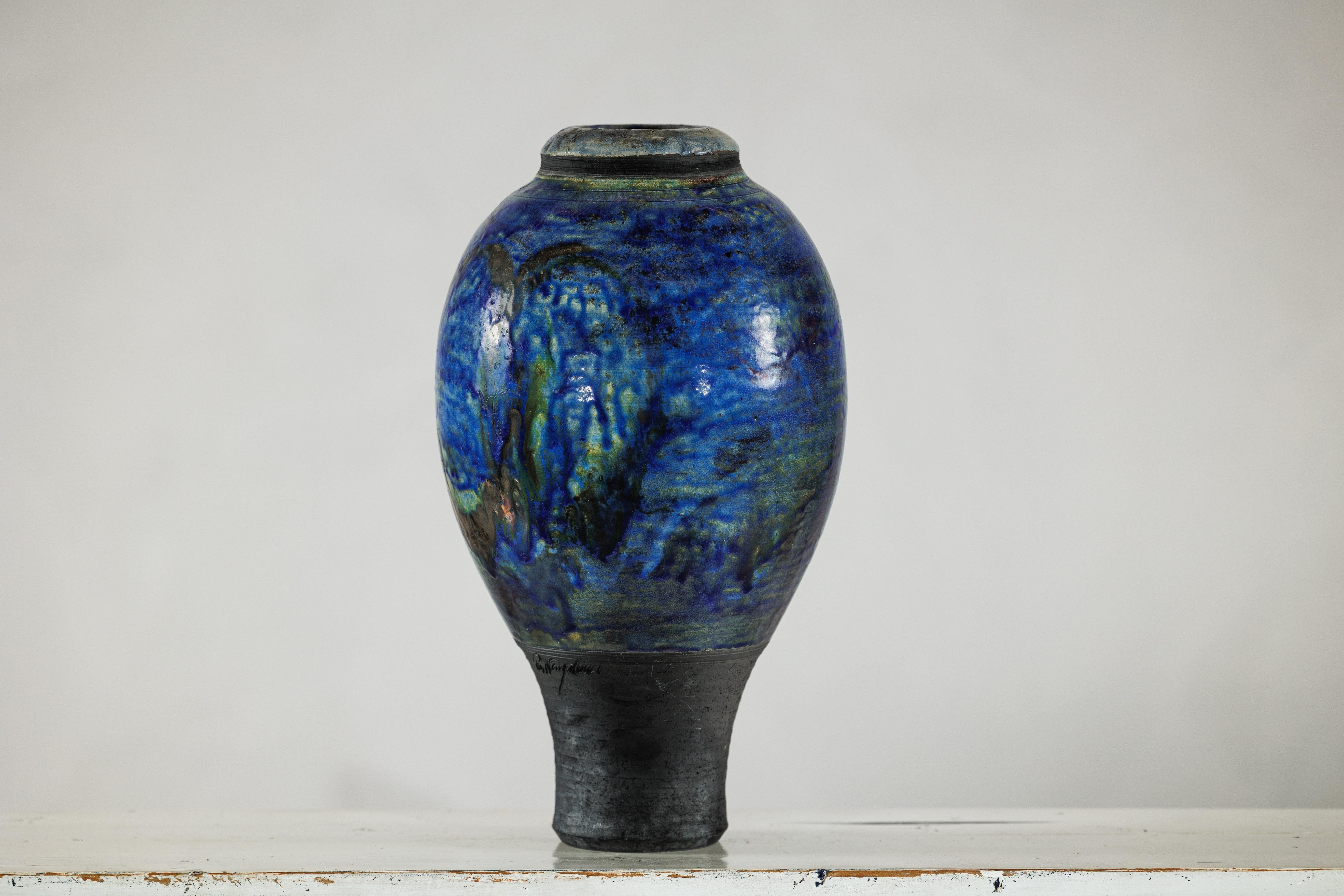 A striking studio pottery vase with a cobalt blue glaze, featuring a bulbous body and a tapered cylindrical foot. Measuring approximately 17.5 inches tall with a 10-inch diameter at its widest and a 2.5-inch mouth opening, the form evokes classic