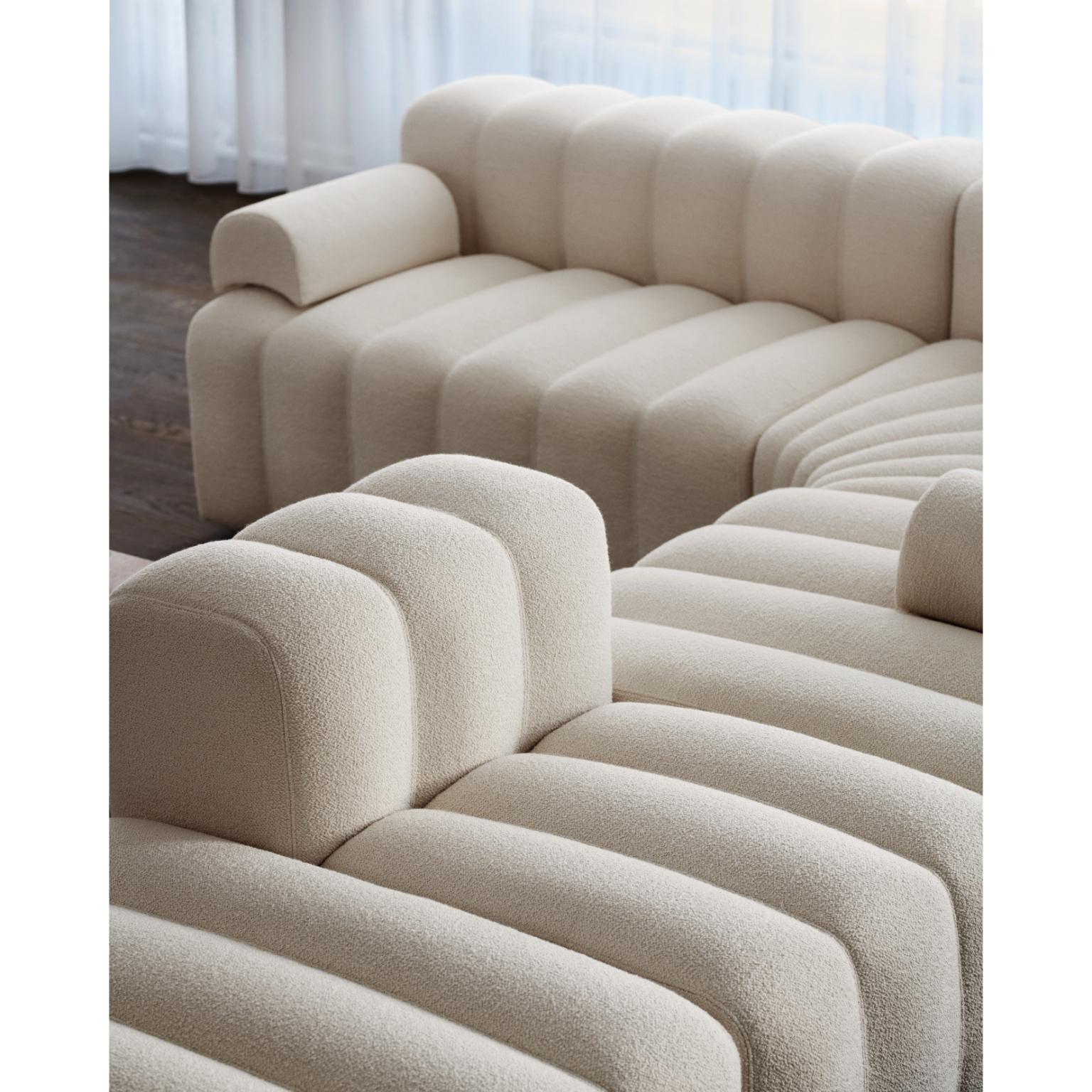 Studio Classic Ottoman by NORR11
Dimensions: D 90 x W 80 x H 47 cm. SH 47 cm. 
Materials: Foam, wood and upholstery.
Upholstery: Barnum Boucle Color 3.
Weight: 25 kg.

Available in different upholstery options. A plywood structure with elastic belts