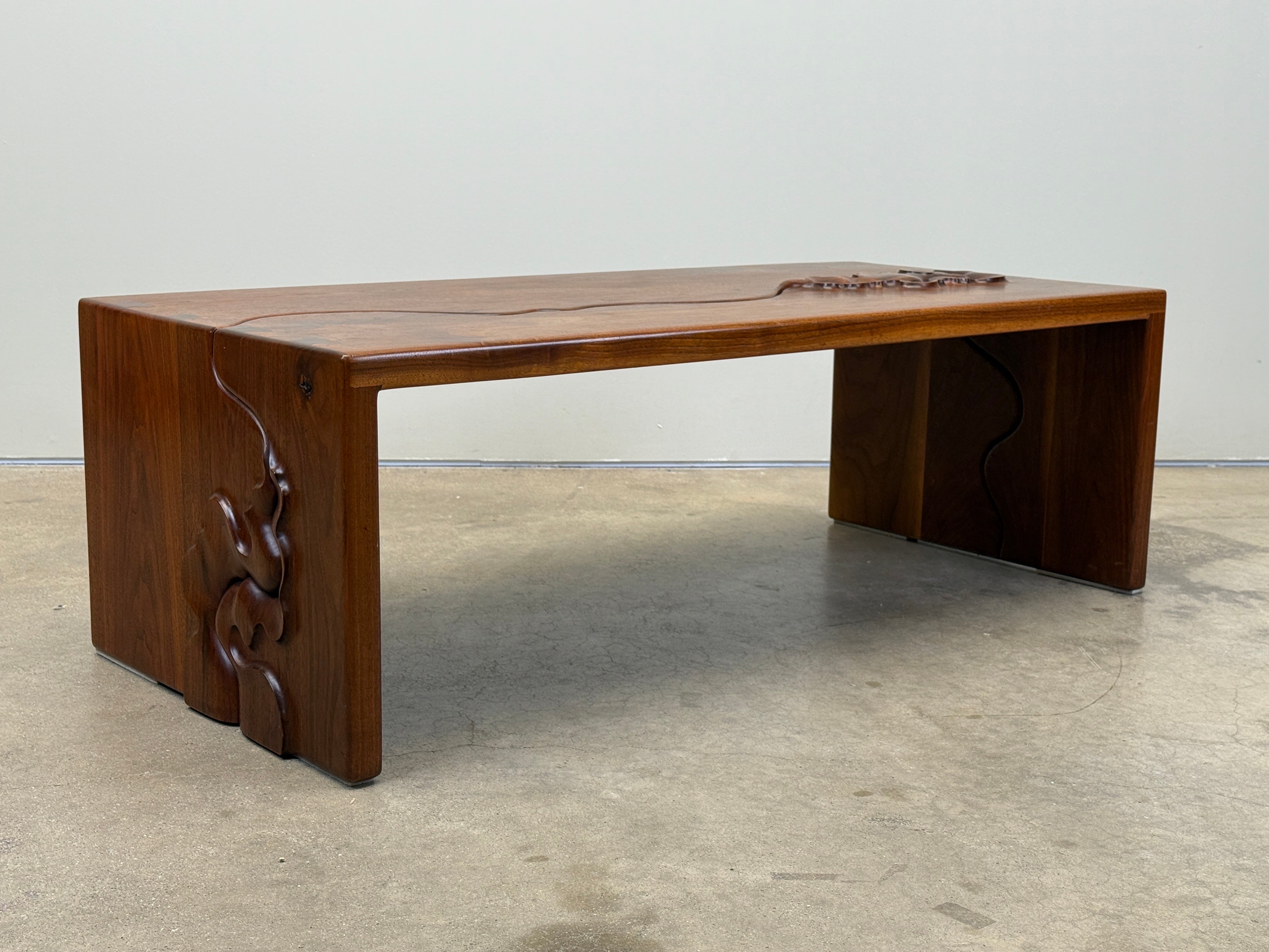 A studio craft walnut coffee table by Robert and Joanne Herzog signed and dated 1985. 