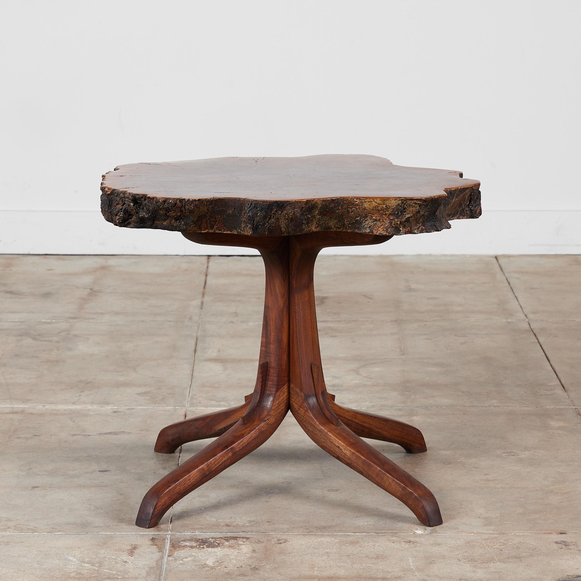 Live edge burl wood occasional table in the style of Sam Maloff. This studio craft table features a thick walnut burl table top with a sculptural walnut pedestal base of four sprawling curved wood legs.

Dimensions: ?31.5
