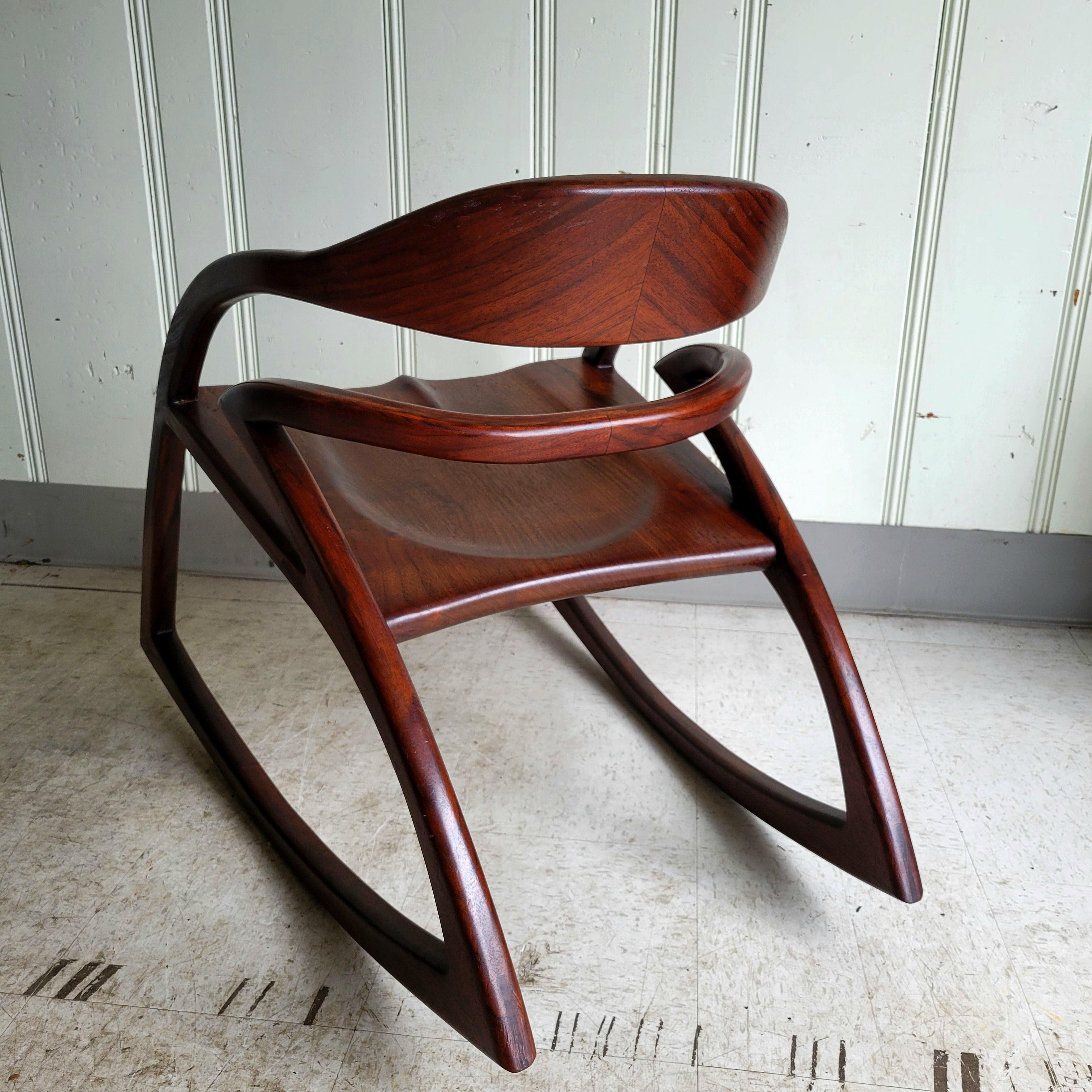 This rocker was handcrafted using Western black walnut using bent lamination for the back rails. Western black walnut is distinctive from other species of walnut in that is known for its highly figured body, variety of reds and purples and its