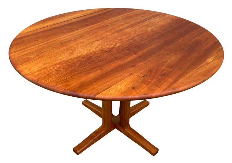 Stunning studio craft round solid cherry dining table by Charles Shackleton made in Vermont, circa 1997. Stamped - beautiful handcrafted dining table. Beautiful solid cherry cluster base and 1.250