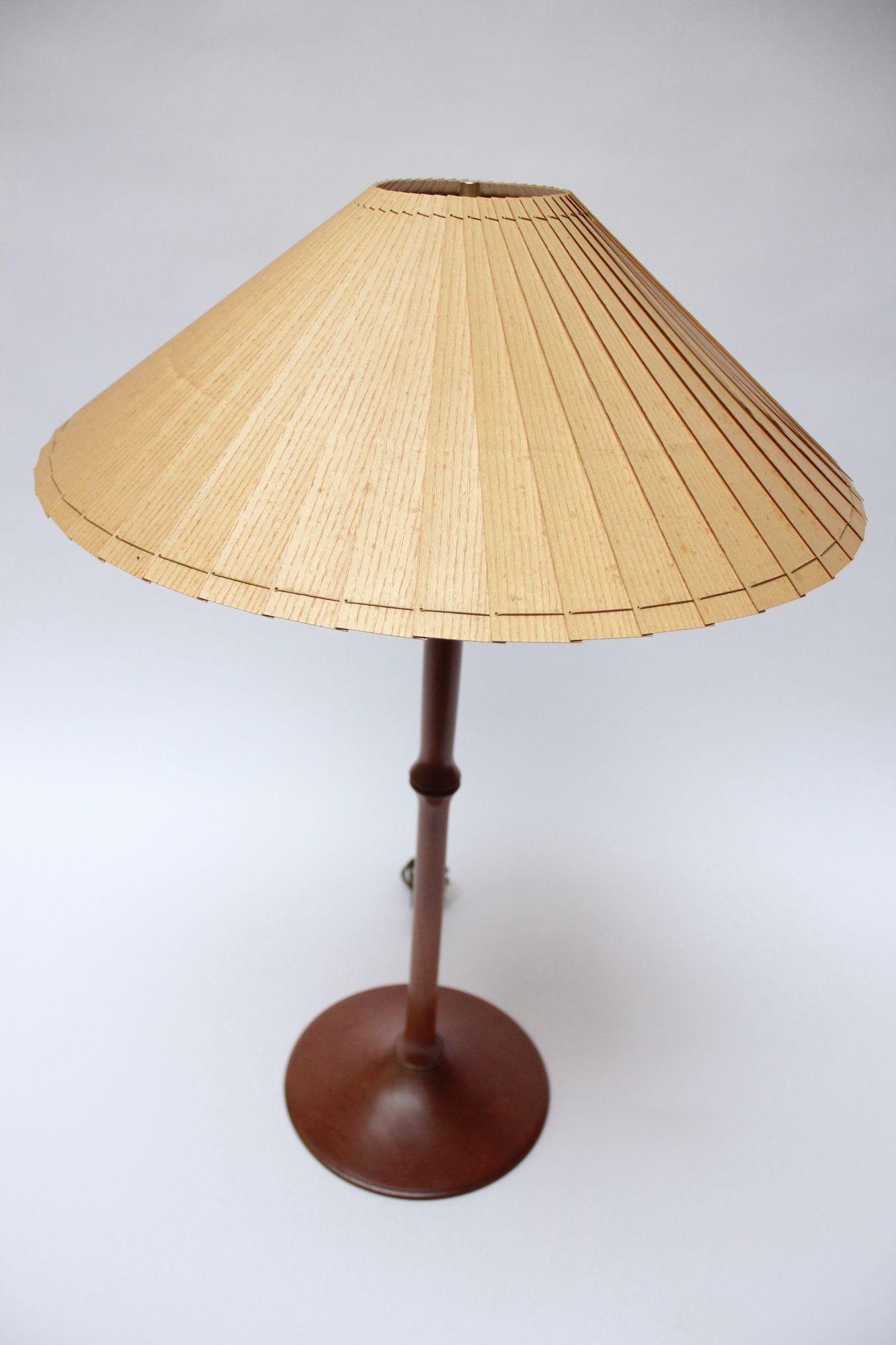 Sculptural cherrywood table lamp with brass accents and original paper shade (Vermont, USA, 1995).
Fitted with a double-socket accommodating two bulbs with an on/off pull-string switch.
Newly rewired condition. Excellent, vintage condition with a