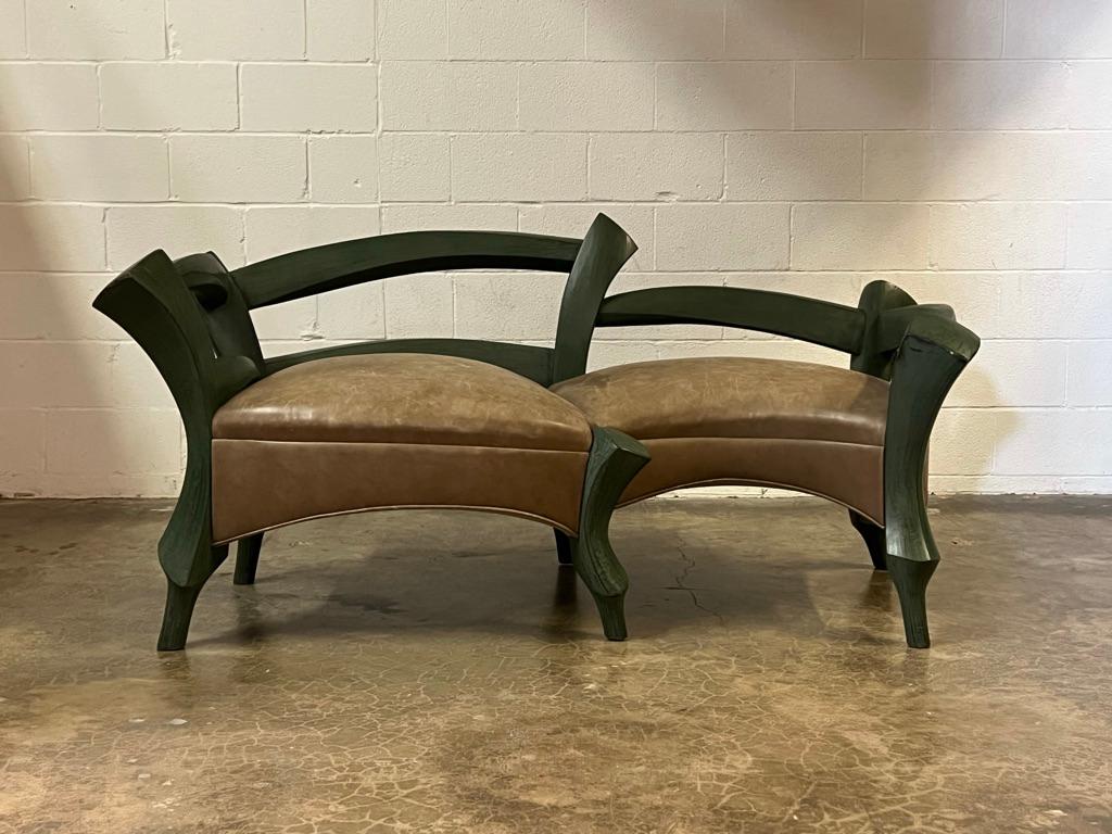 A beautifully made studio craft sofa / bench with green lacquered frame and patinated leather upholstery.