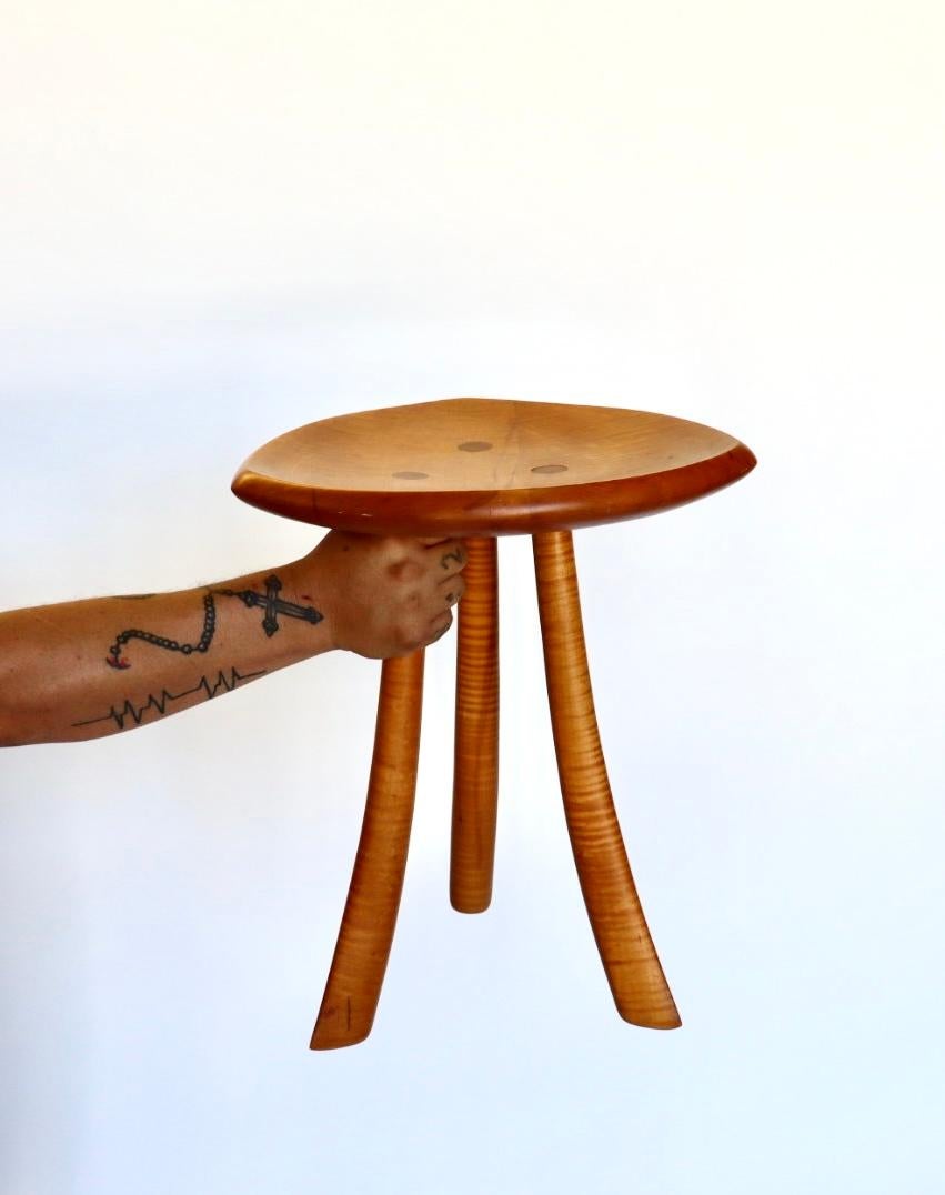This small Studio craft stool by Steven Spiro packs an outsized punch of attitude and charm. It is crafted out of beautiful solid maple wood. Steven Spiro is an American studio craft artist making organic furniture by hand. He has been featured in
