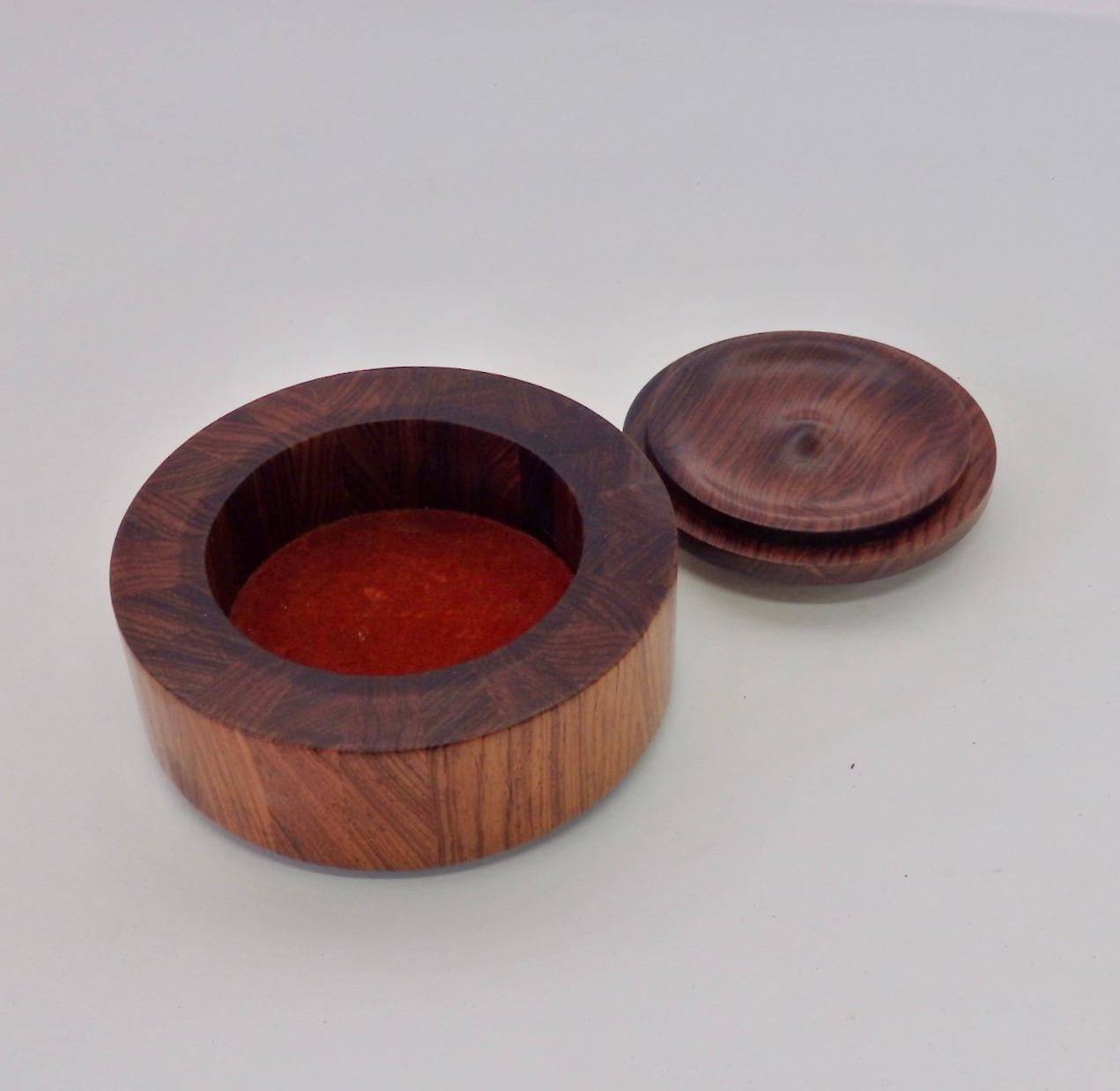 Nicely crafted solid rosewood box with enameled lid.