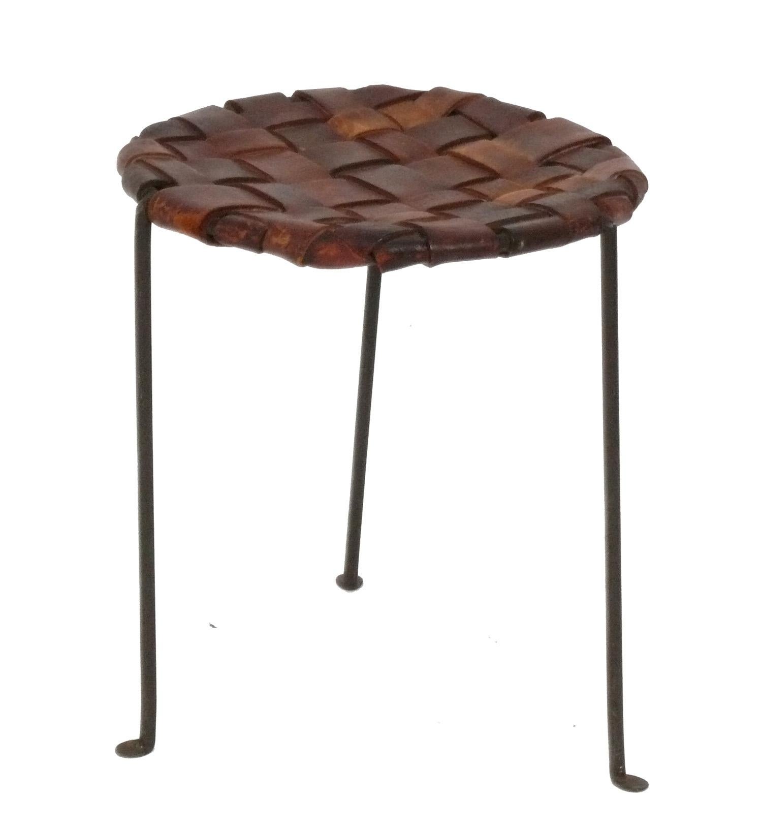 Studio Craft Woven Leather and Iron Stool, hand made by Lila Swift and Donald Monell, American, circa 1950s. The beautiful combination of the original patinated woven leather and the iron lend texture and warmth to any interior. The leather has been