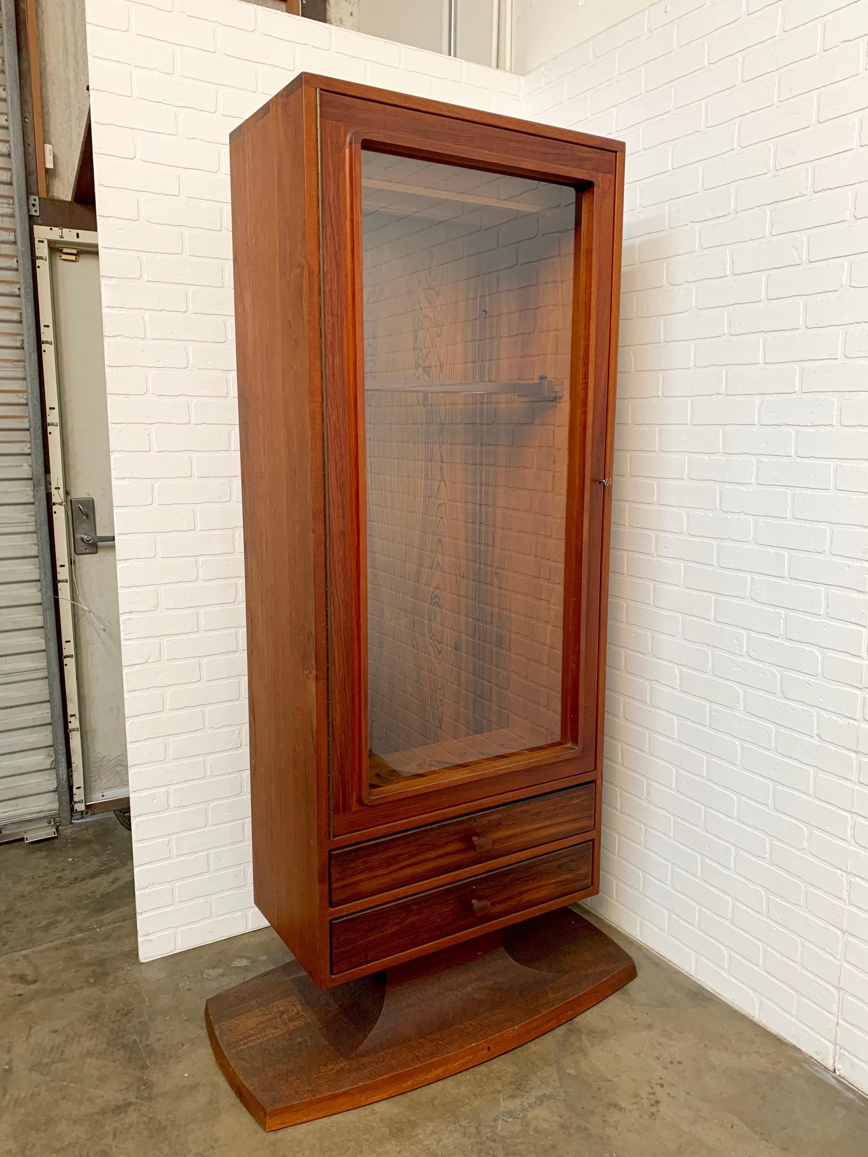 Sculpted walnut pedestal rifle / gun / trophy cabinet with rosewood, maple accents. Locking glass door for security, signed on base
Expert joinery by master craftsman John Nyquist
Case dimensions: 30 L x 16.5 D
Base dimensions: 42