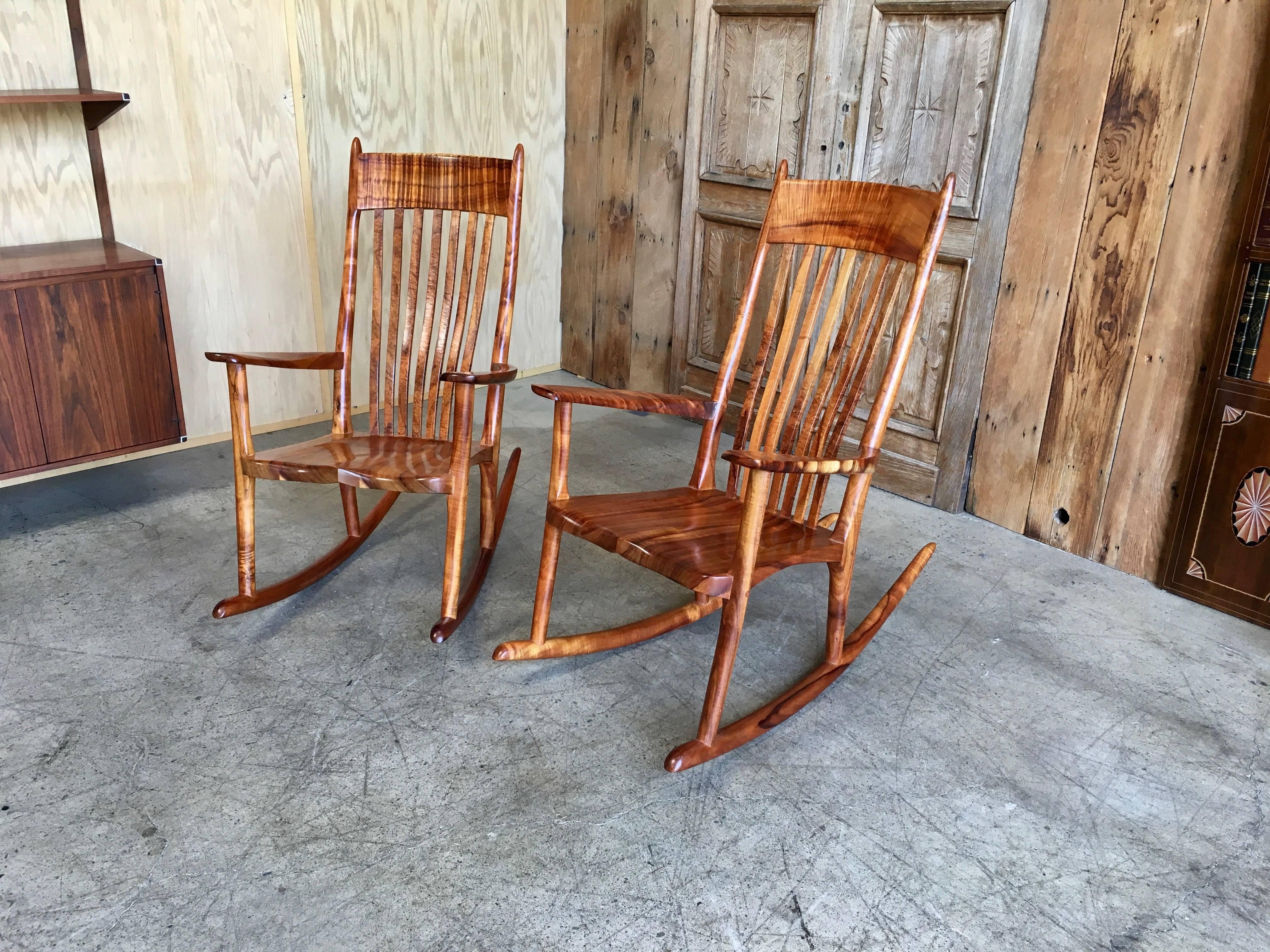 Pair of late 20th century. Slat-back rocking armchairs made of beautifully figured koa wood from the Raiatea Woodworks, Paavilo, Hawaii, signed Stan Gollaher.