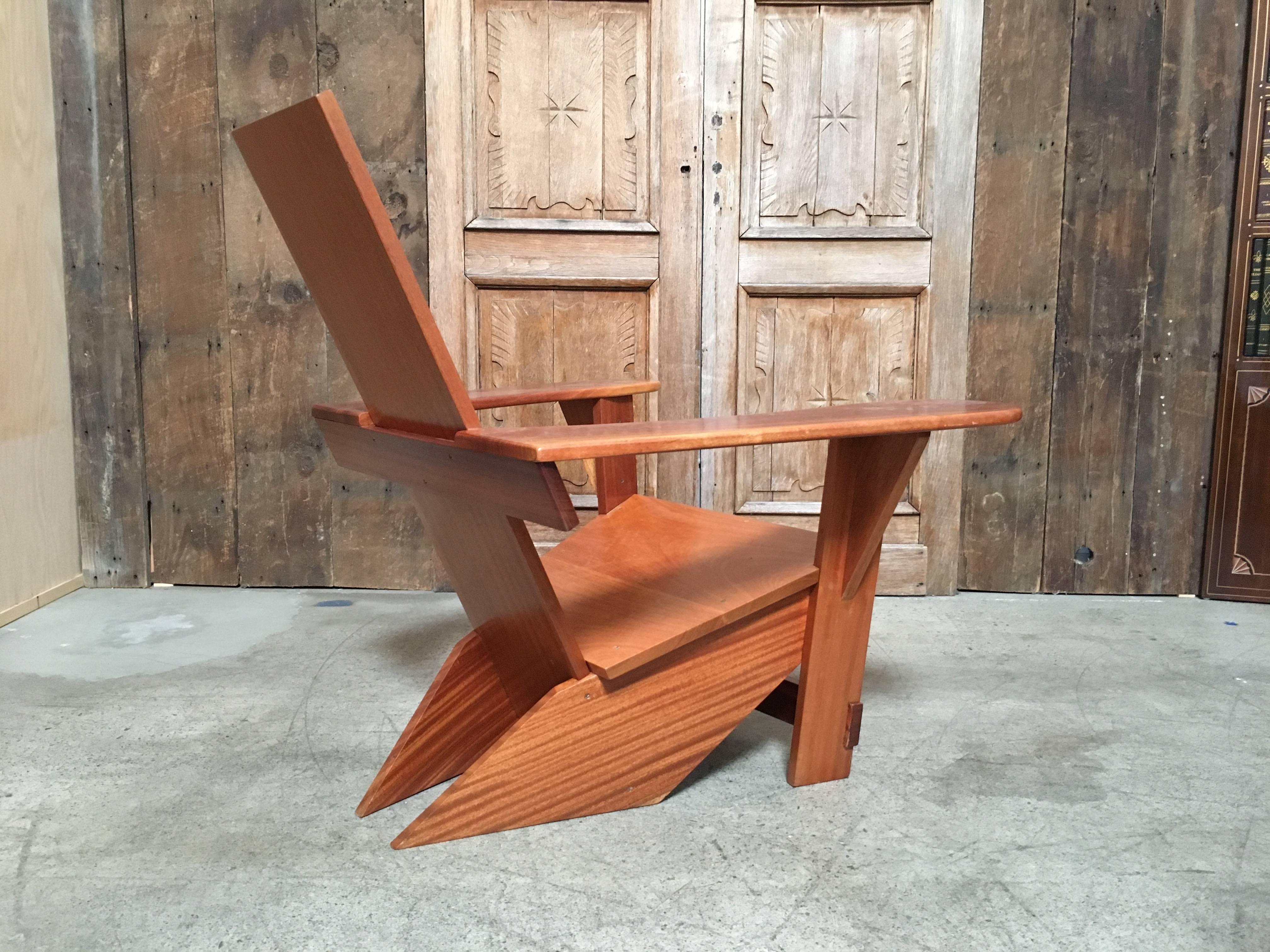 Rich mahogany handcrafted adirondack chair with a modernist flair with exposed brass screws.