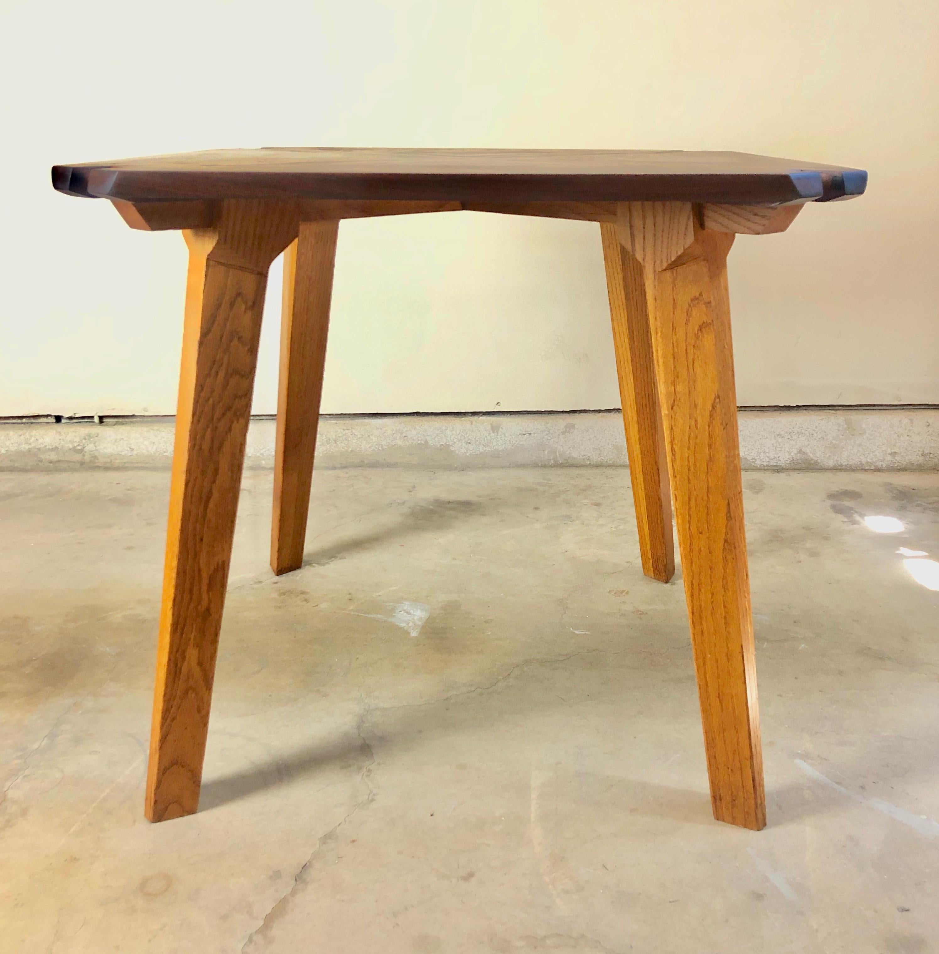 Studio crafted mixed woods dining table. Petite sized dining table that can also be used as a game table. This table fits perfectly into small spaces.
