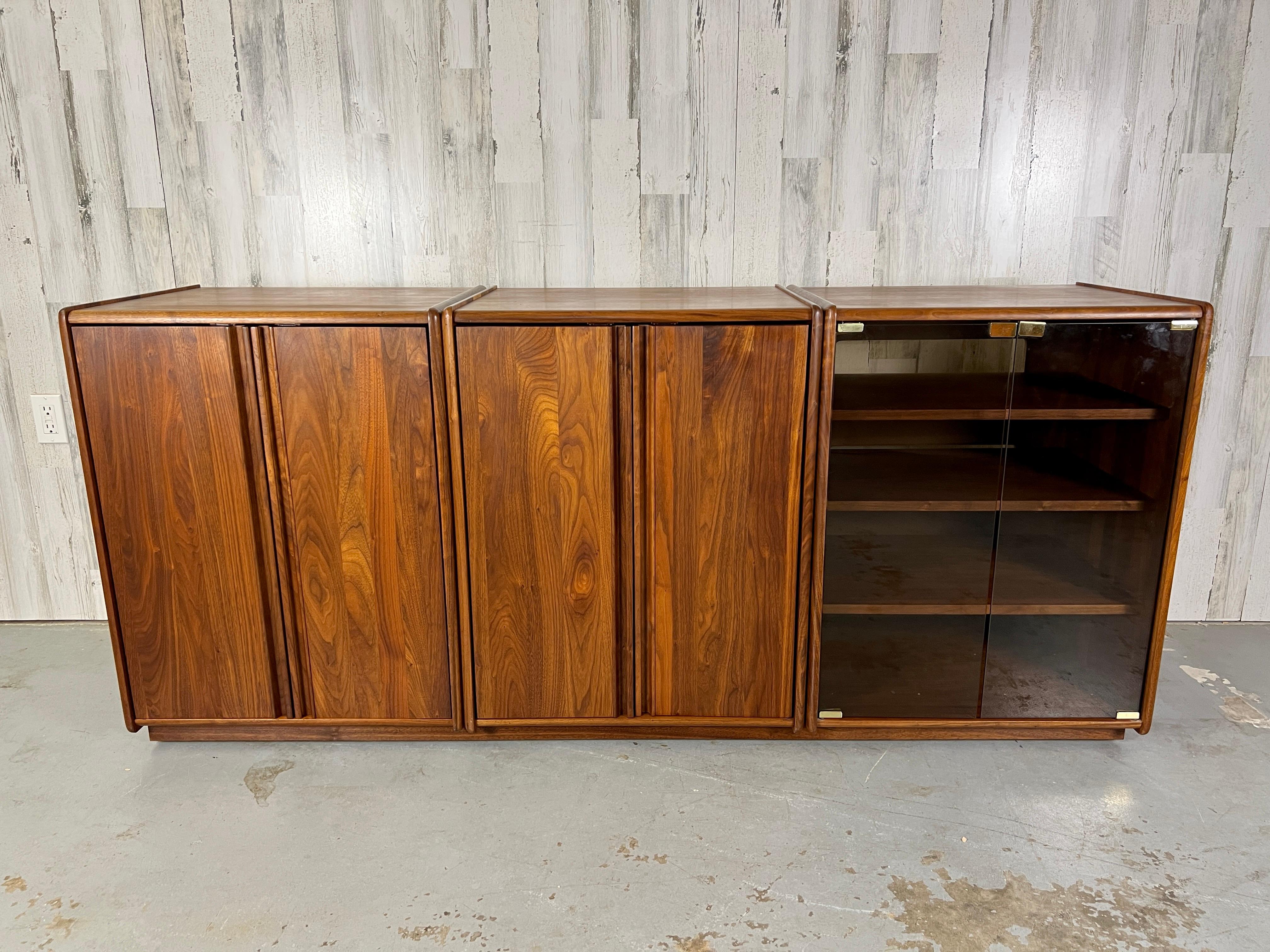 Studio crafted solid walnut modular cabinet system. There are two cabinets with solid walnut doors an one cabinet with smoked glass Doors .plenty of shelves for all your stereo equipment.
Made by woodworking & Design inc.