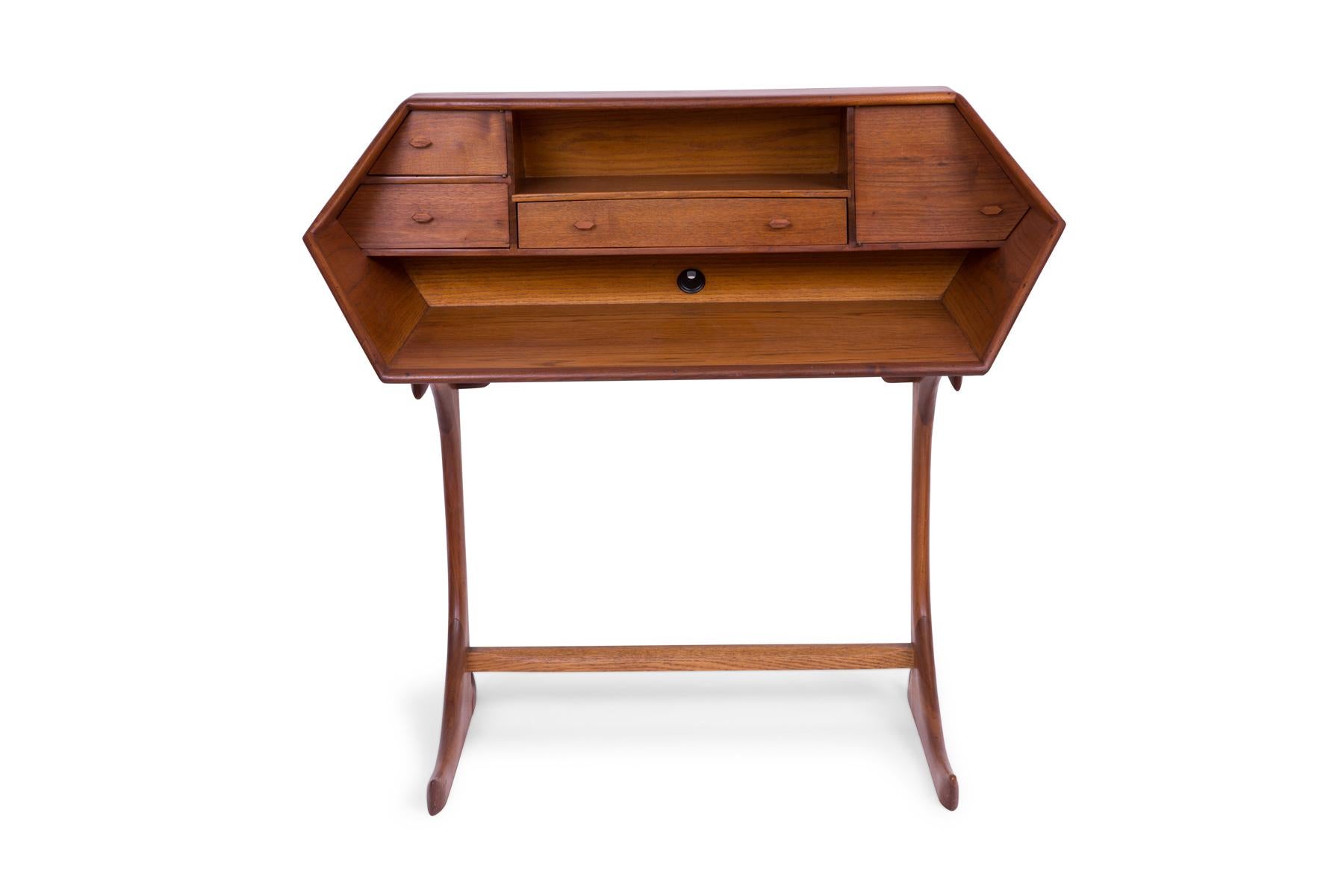 Studio crafted walnut and oak desk circa late 1960s. This sculptural example incorporates stunning form with incredible ease of function. The wood grain is striking, and each drawer and surface masterfully crafted.