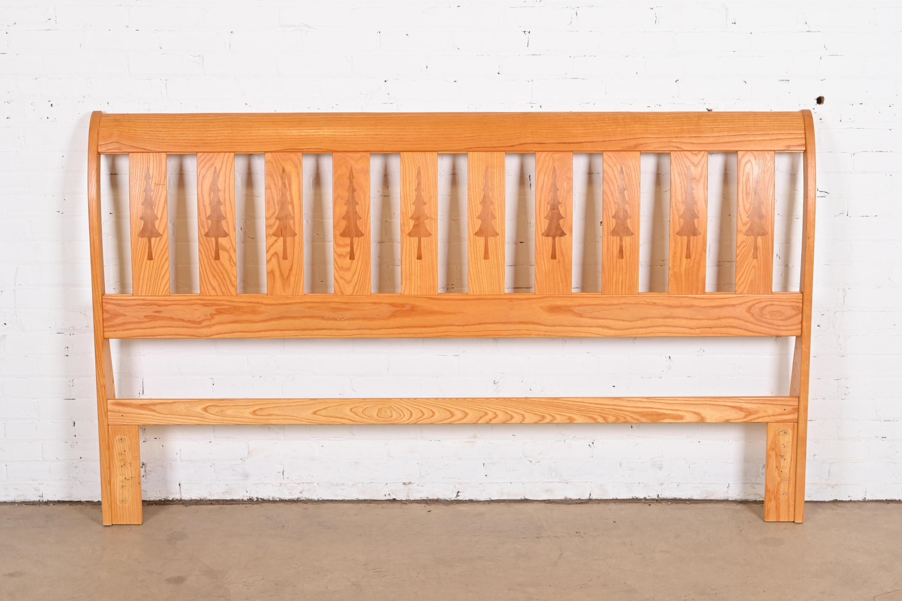 A gorgeous studio crafted Western rustic lodge style king size headboard

By David Fite Studios

USA, Late 20th Century

Sculpted pine, with inlaid evergreen trees.

Measures: 82.25