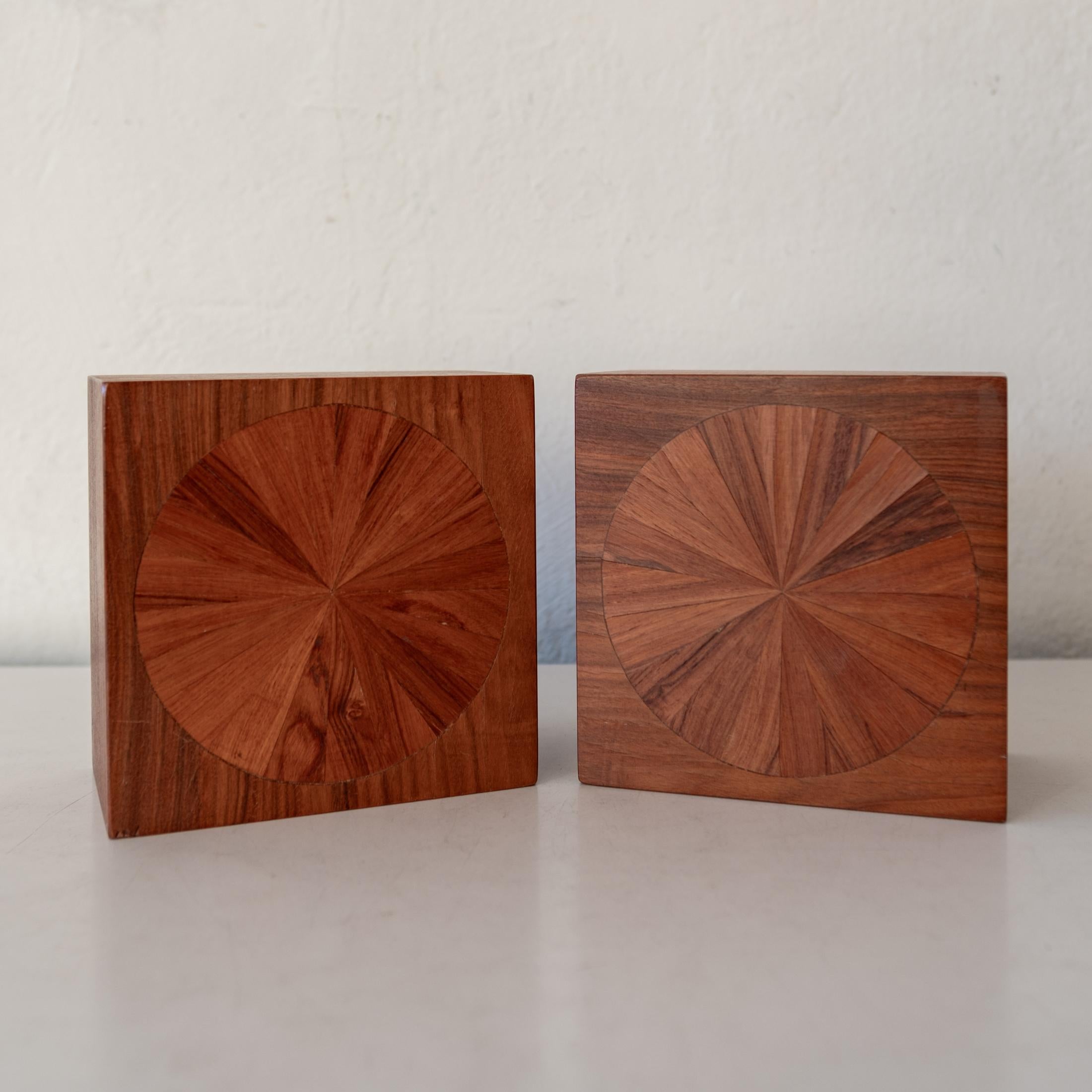 A pair of bookends by Jere Osgood. Handcrafted with incredible detail and marquetry. 

This particular design was sold through the American Craft Council's gallery,  America House (see catalog page). The shop operated from the 1940's to 1970s in New