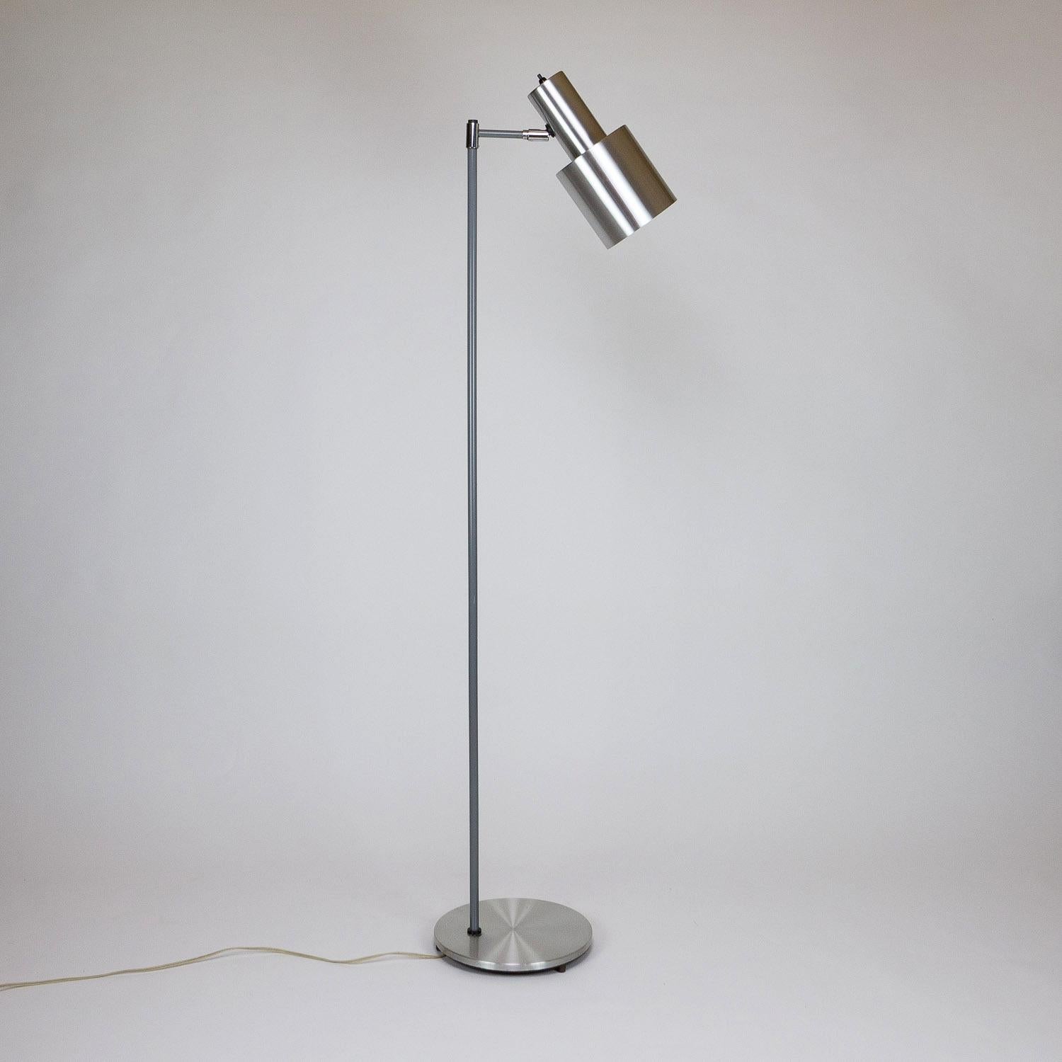 Studio floor lamp with spun aluminum adjustable shade and base with grey coated metal leg. Designed by Jo Hammerborg for Fog & Mørup, Denmark in 1963. Scuffs and scratches on the shade.

    